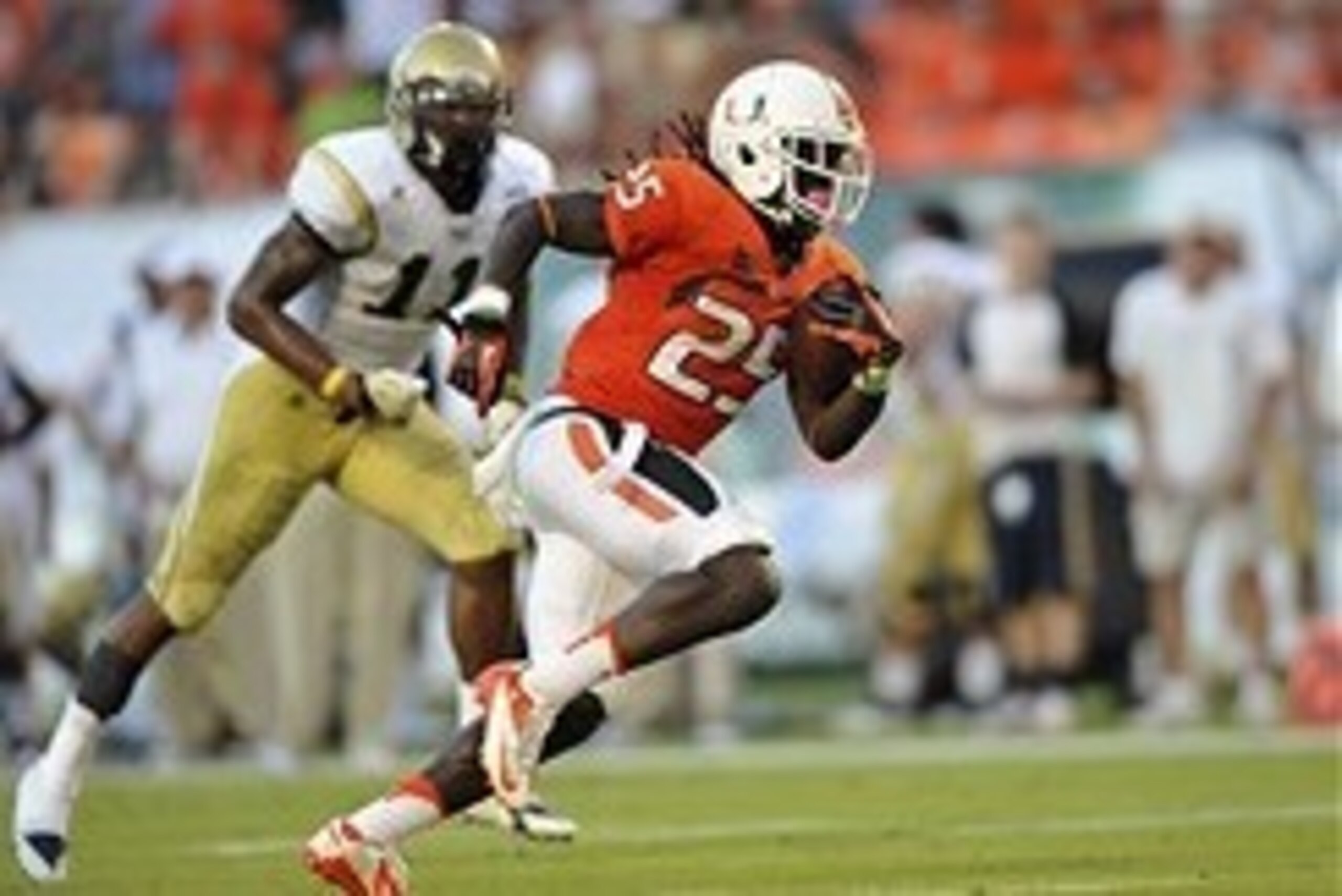 Oct 5, 2013; Miami Gardens, FL, USA; Miami Hurricanes running back Dallas Crawford (25) runs in a touchdown past Georgia Tech Yellow Jackets linebacker Brandon Watts (11) during the second half at Sun Life Stadium. Mandatory Credit: Steve Mitchell-USA TOD