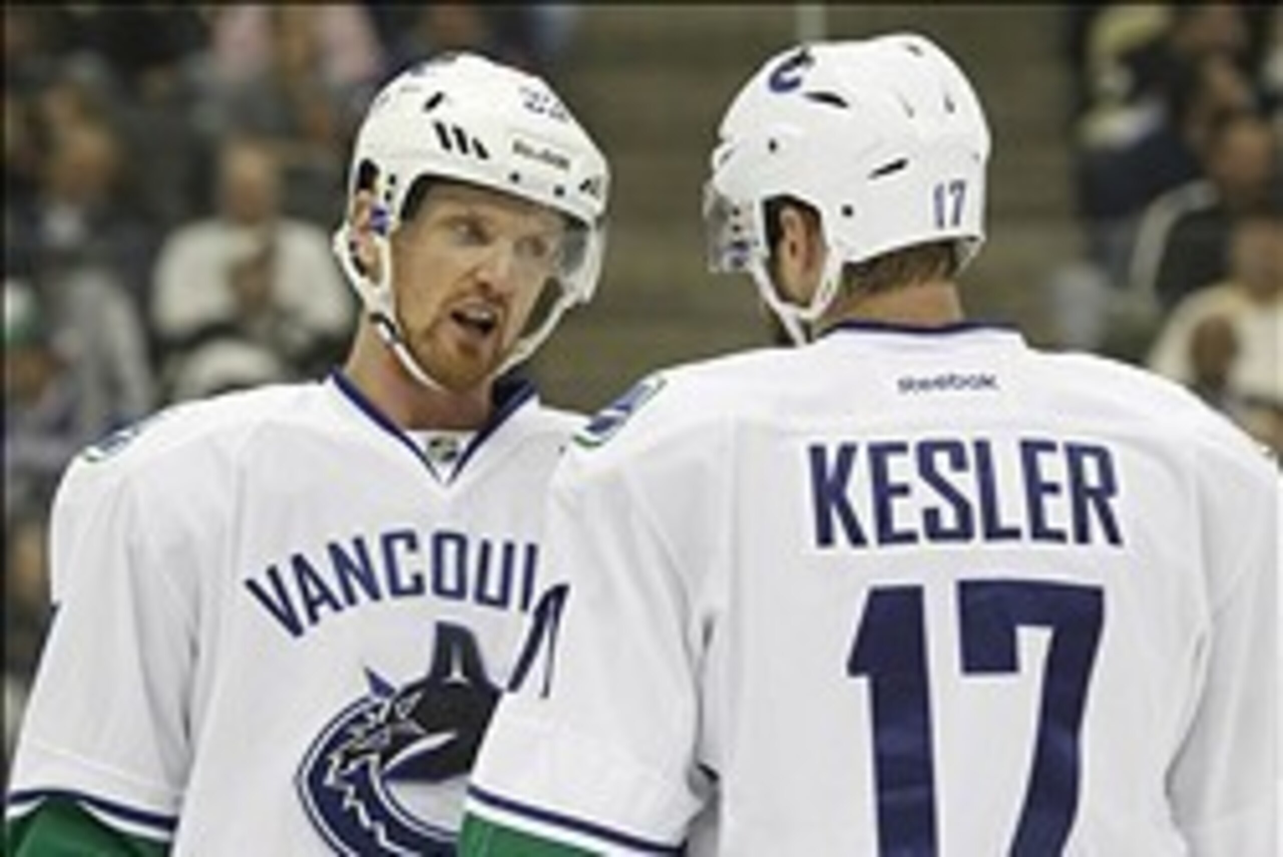 Oct 19, 2013; Pittsburgh, PA, USA; Vancouver Canucks center Henrik Sedin (33) and center Ryan Kesler (17) talk on the ice against the Pittsburgh Penguins during the first period at the CONSOL Energy Center. The Pens won 4-3 in a shootout. Mandatory Credit