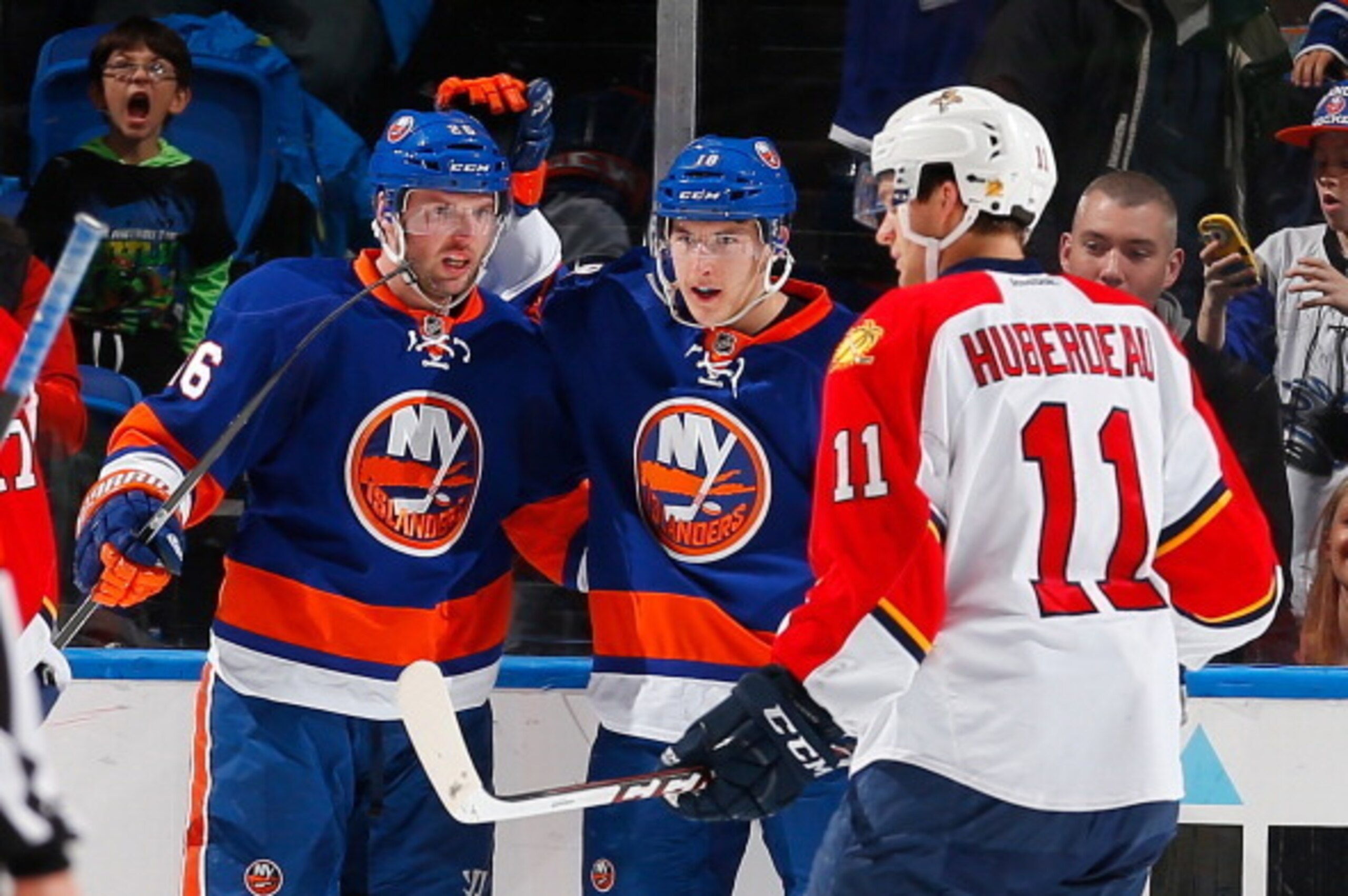 UNIONDALE, NY - MARCH 02: Ryan Strome #18 of the New York Islanders is congratulated on his second period goal by teammate Thomas Vanek #26 while Jonathan Huberdeau #11 of the Florida Panthers looks away at Nassau Veterans Memorial Coliseum on March 2, 20
