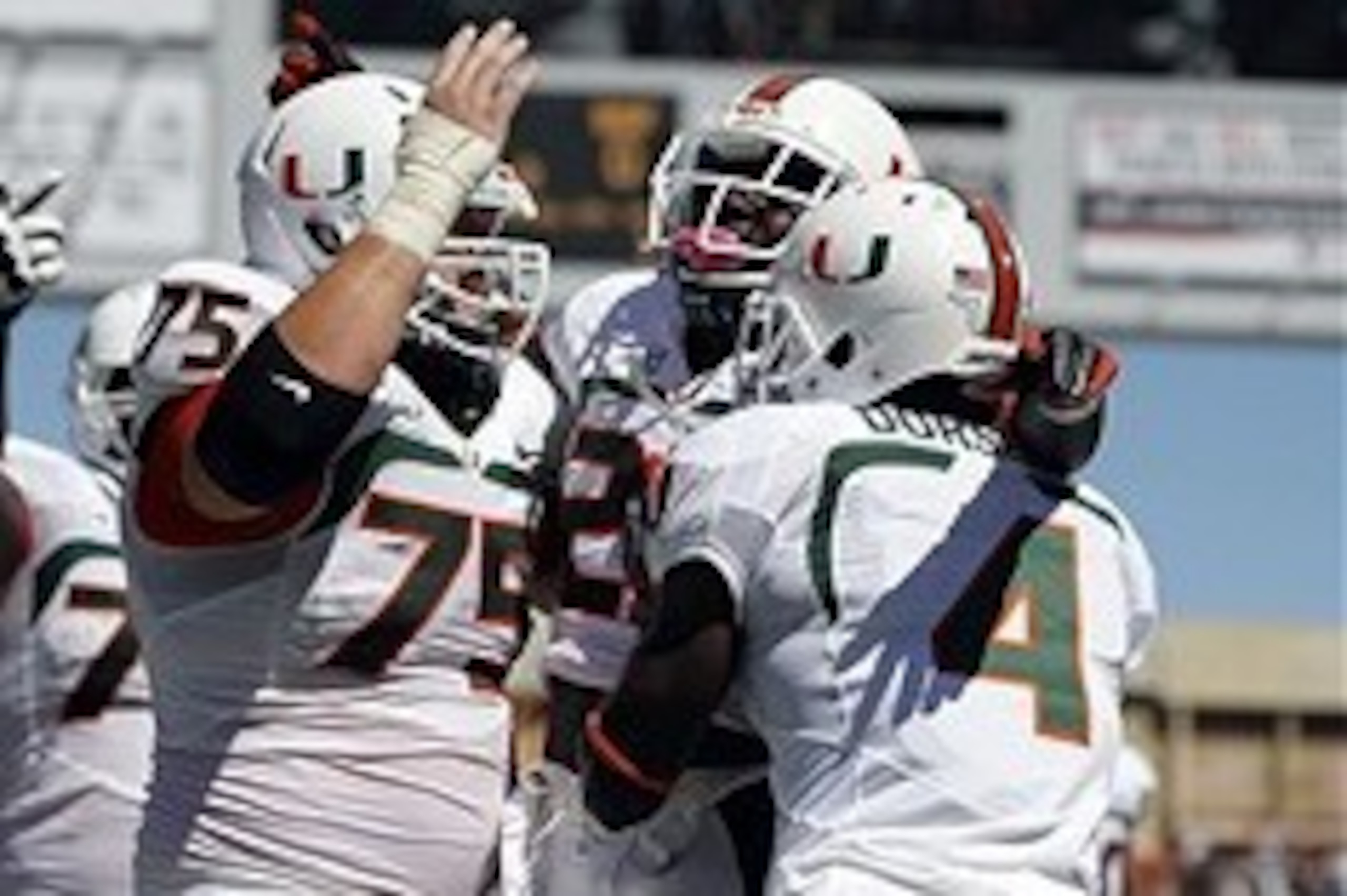 Sep 28, 2013; Tampa, FL, USA; Miami Hurricanes running back Dallas Crawford (25) is congratulated by teammates after he ran the ball in for a touchdown during the first quarter against the South Florida Bulls at Raymond James Stadium. Mandatory Credit: Ki