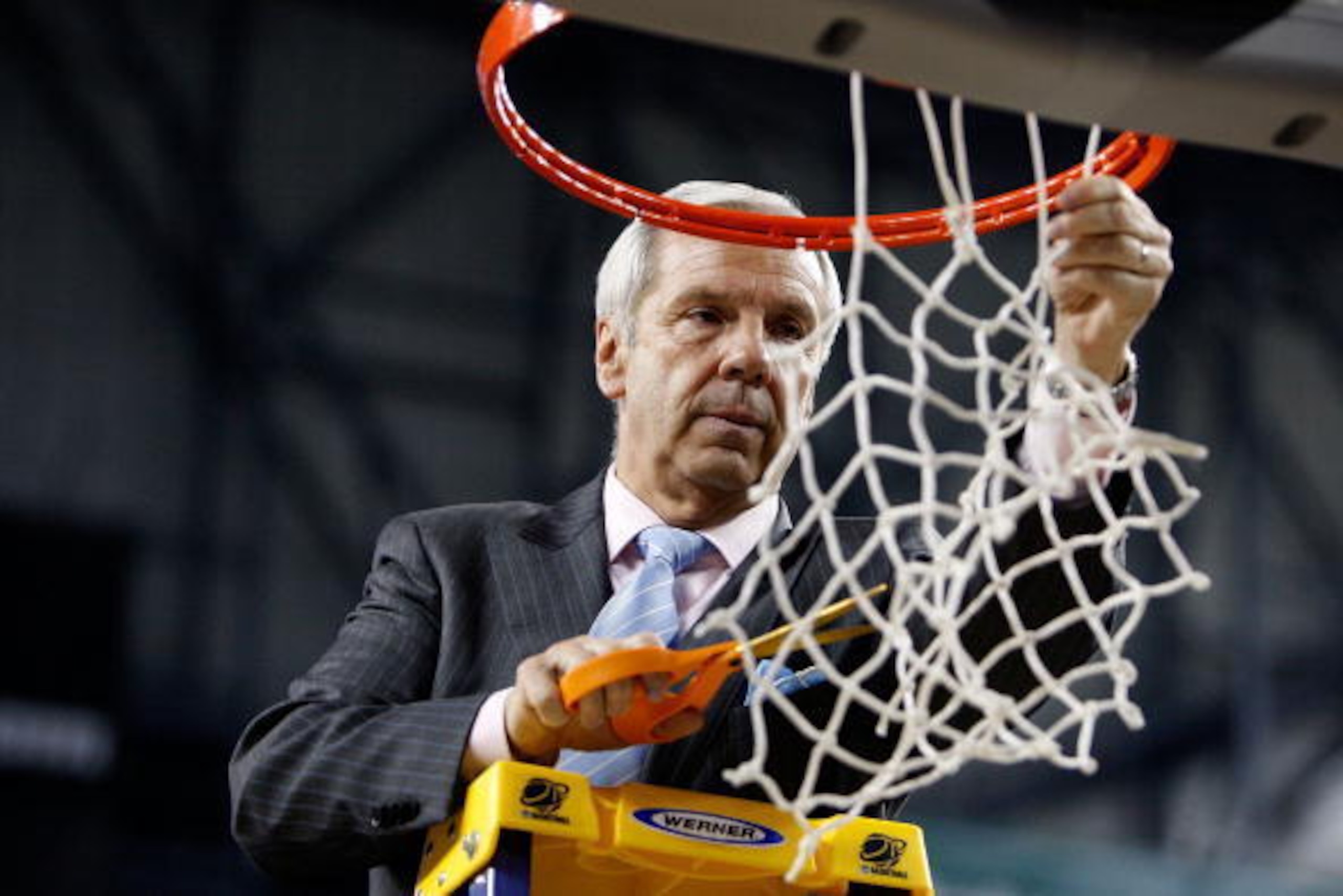 DETROIT - APRIL 06:  Head coach Roy Williams of the North Carolina Tar Heels cuts down a piece of the net after they 89-72 win against the Michigan State Spartans during the 2009 NCAA Division I Men's Basketball National Championship game at Ford Field on