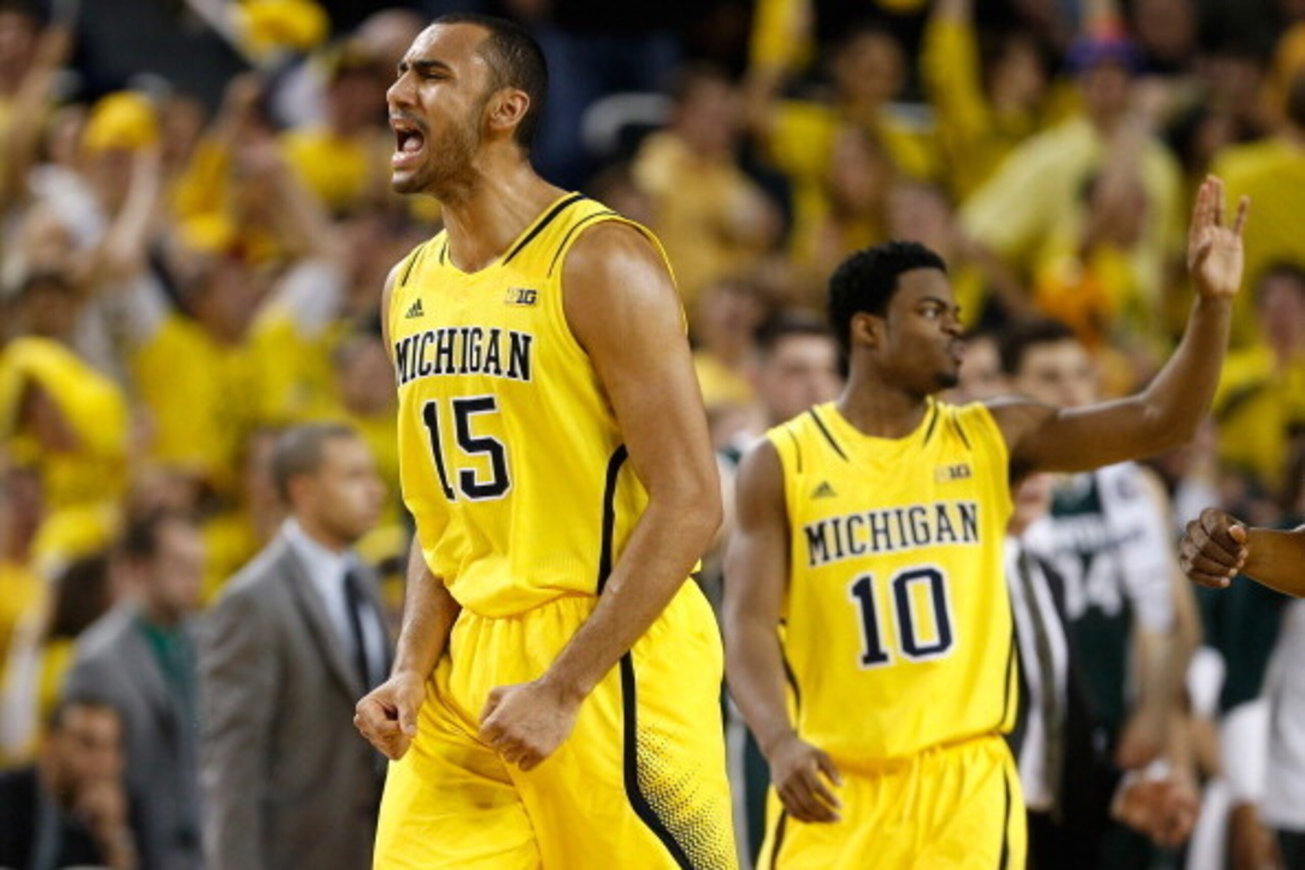 ANN ARBOR, MI - FEBRUARY 23: Jon Horford #15 of the Michigan Wolverines reacts in front of teammate Derrick Walton Jr. #10 during the second half while playing the Michigan State Spartans at Crisler Center on February 23, 2014 in Ann Arbor, Michigan. Mich
