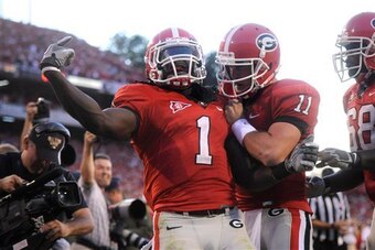 Crowell and quarterback Aaron Murray celebrate following a score against South Carolina in 2011.