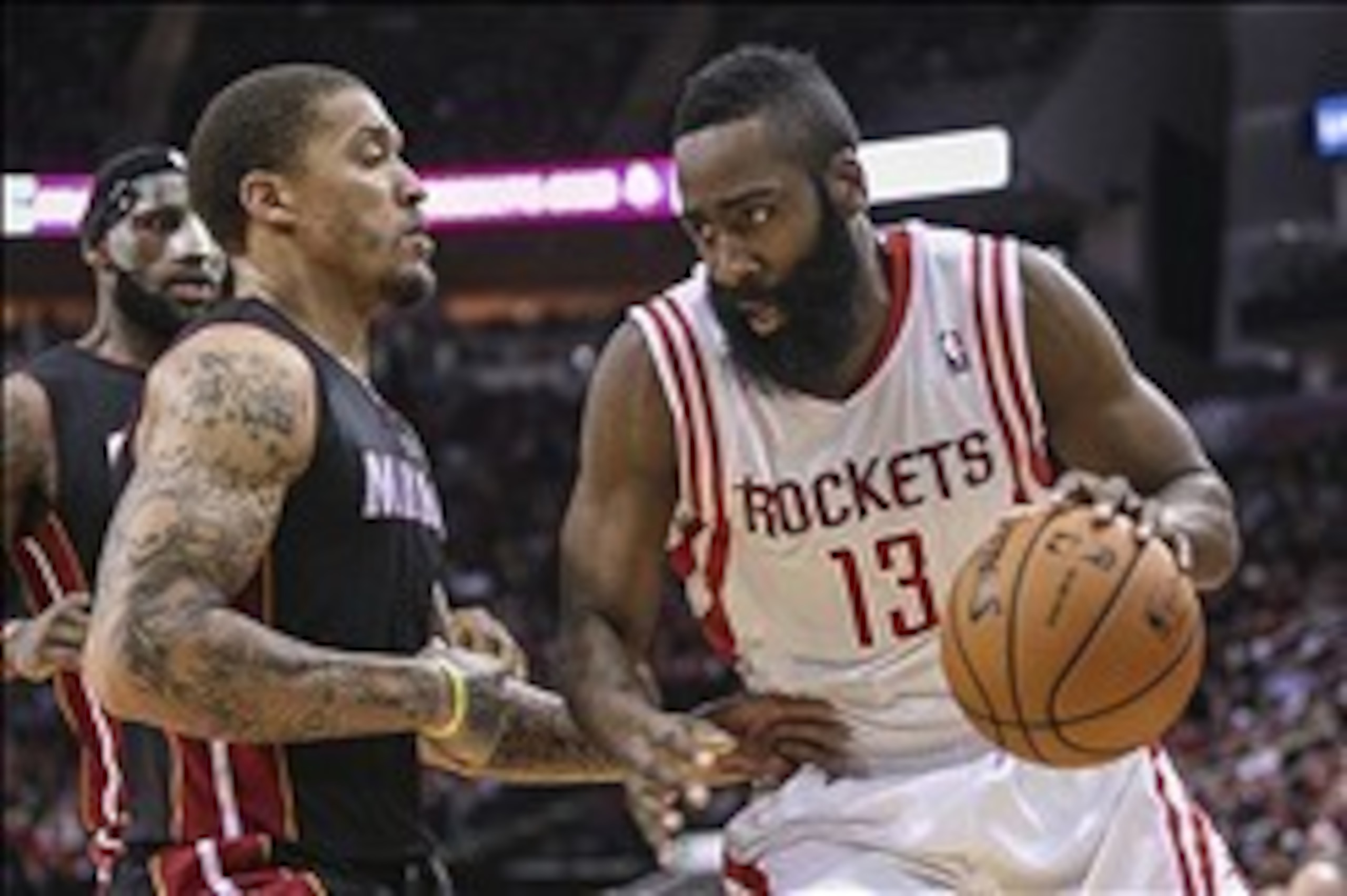 Mar 4, 2014; Houston, TX, USA; Houston Rockets shooting guard James Harden (13) drives to the basket during the second quarter as Miami Heat small forward Michael Beasley (8) defends at Toyota Center. Mandatory Credit: Troy Taormina-USA TODAY Sports