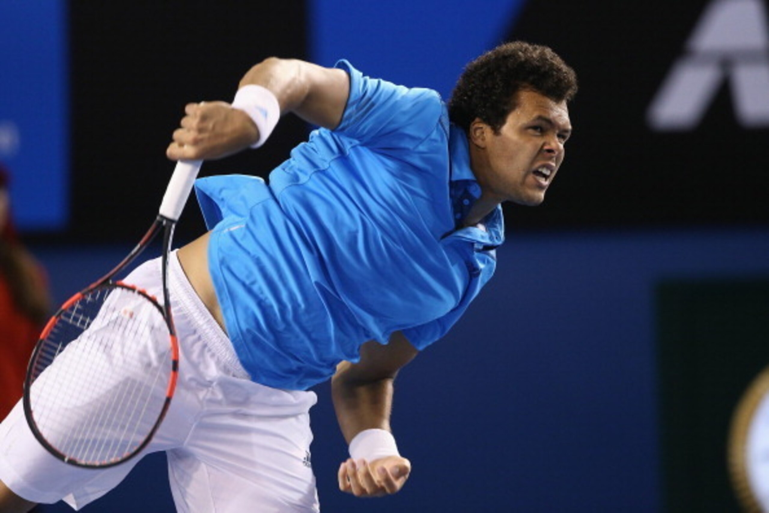 MELBOURNE, AUSTRALIA - JANUARY 20: Jo-Wilfried Tsonga of France serves in his fourth round match against Roger Federer of Switzerland during day eight of the 2014 Australian Open at Melbourne Park on January 20, 2014 in Melbourne, Australia. (Photo by C MELBOURNE, AUSTRALIA - JANUARY 20: Jo-Wilfried Tsonga of France serves in his fourth round match against Roger Federer of Switzerland during day eight of the 2014 Australian Open at Melbourne Park on January 20, 2014 in Melbourne, Australia. (Photo by C