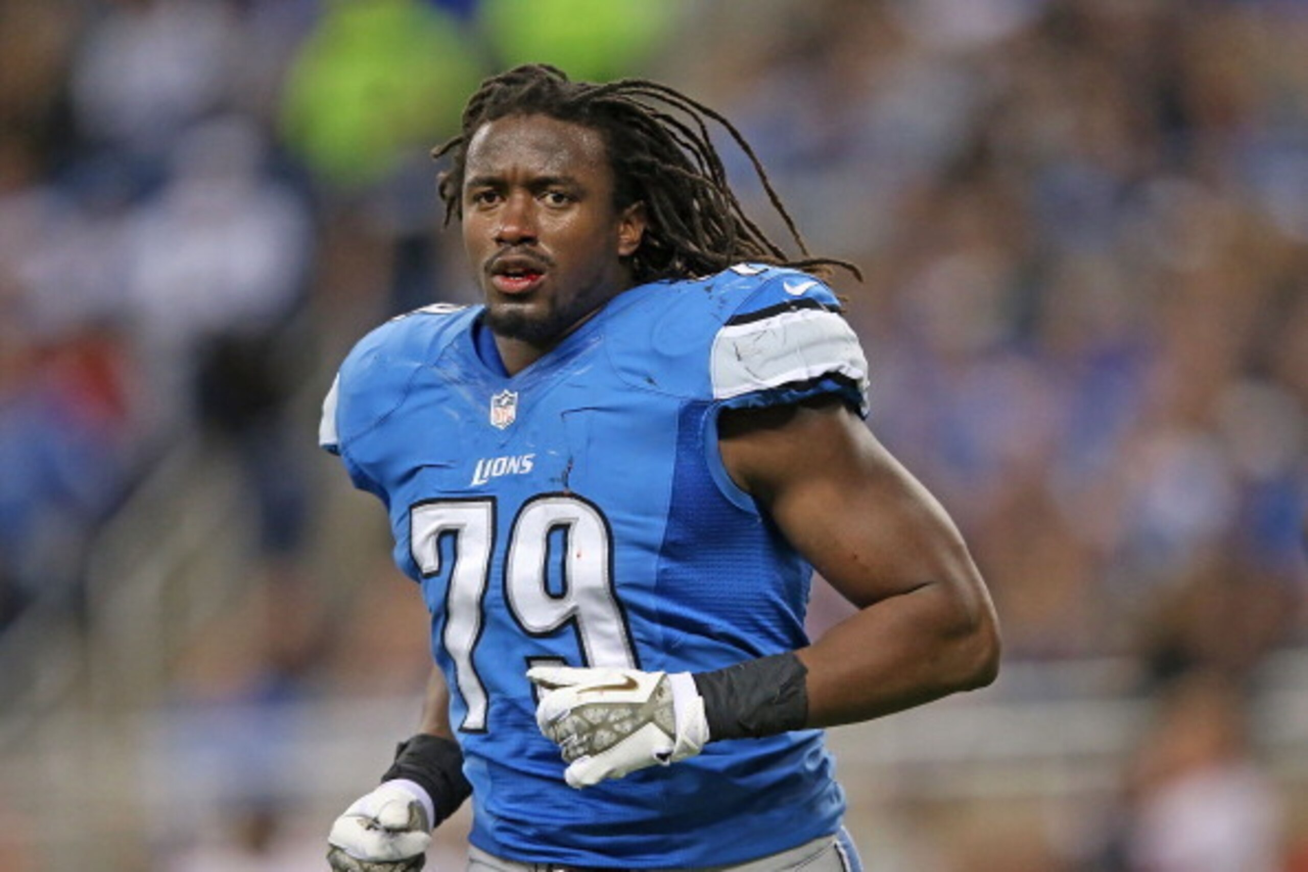 DETROIT, MI - NOVEMBER 24:  Willie Young #79 of the Detroit Lions runs off the field after losing his helmet during the last play of the third quarter during the game against the Tampa Bay Buccaneers at Ford Field on November 24, 2013 in Detroit, Michigan