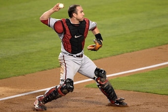 LOS ANGELES, CA - SEPTEMBER 10:  Miguel Montero #26 of the Arizona Diamondbacks makes a throwing error to second after fielding a bunt from Edinson Volquez #30 of the Los Angeles Dodgers allowing Juan Uribe #5 to score for a 1-0 lead during the second inn