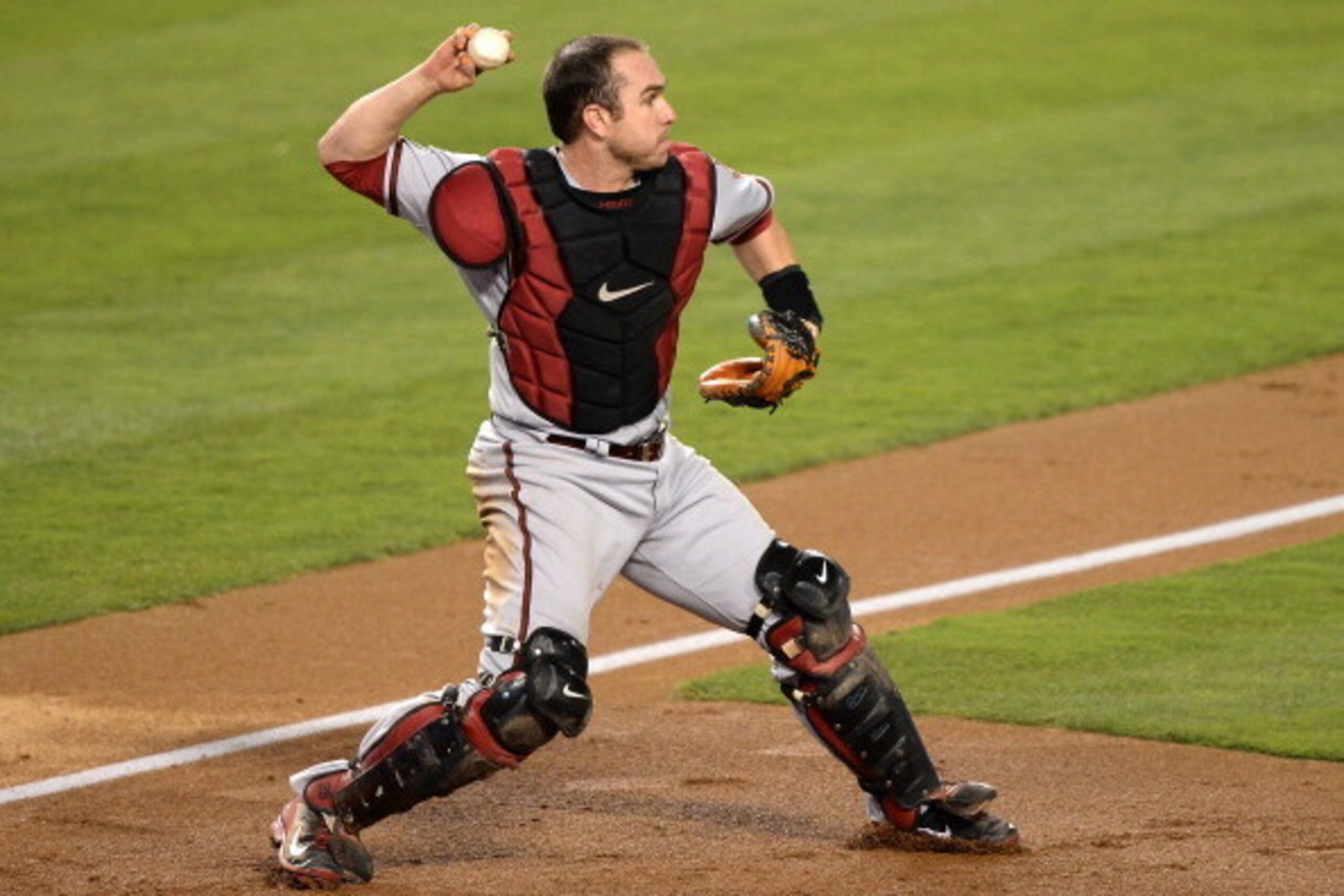 LOS ANGELES, CA - SEPTEMBER 10:  Miguel Montero #26 of the Arizona Diamondbacks makes a throwing error to second after fielding a bunt from Edinson Volquez #30 of the Los Angeles Dodgers allowing Juan Uribe #5 to score for a 1-0 lead during the second inn