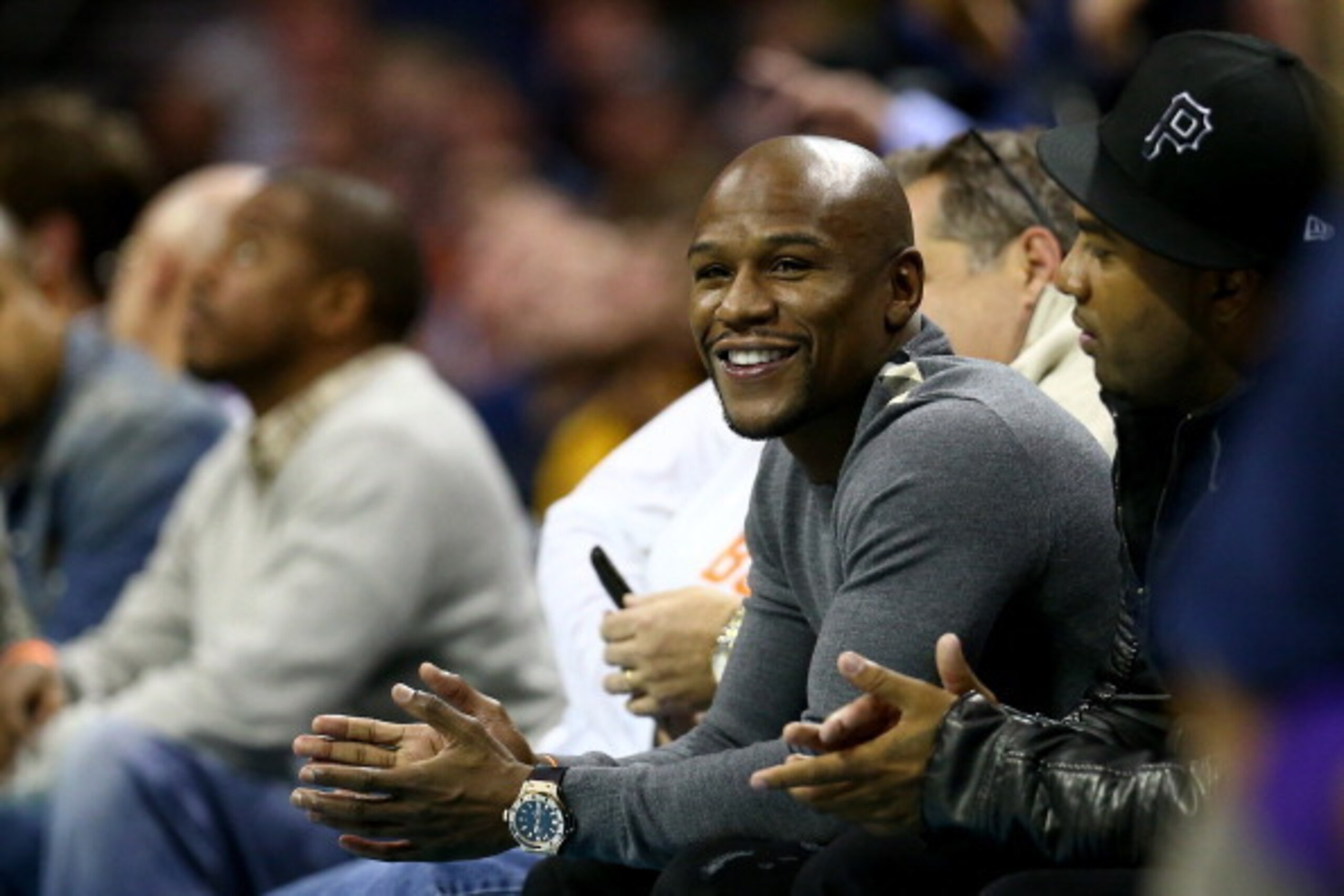 CHARLOTTE, NC - DECEMBER 14:  Professional boxer Floyd Mayweather Jr. watches on during the game between the Los Angeles Lakers and Charlotte Bobcats at Time Warner Cable Arena on December 14, 2013 in Charlotte, North Carolina.  NOTE TO USER: User express