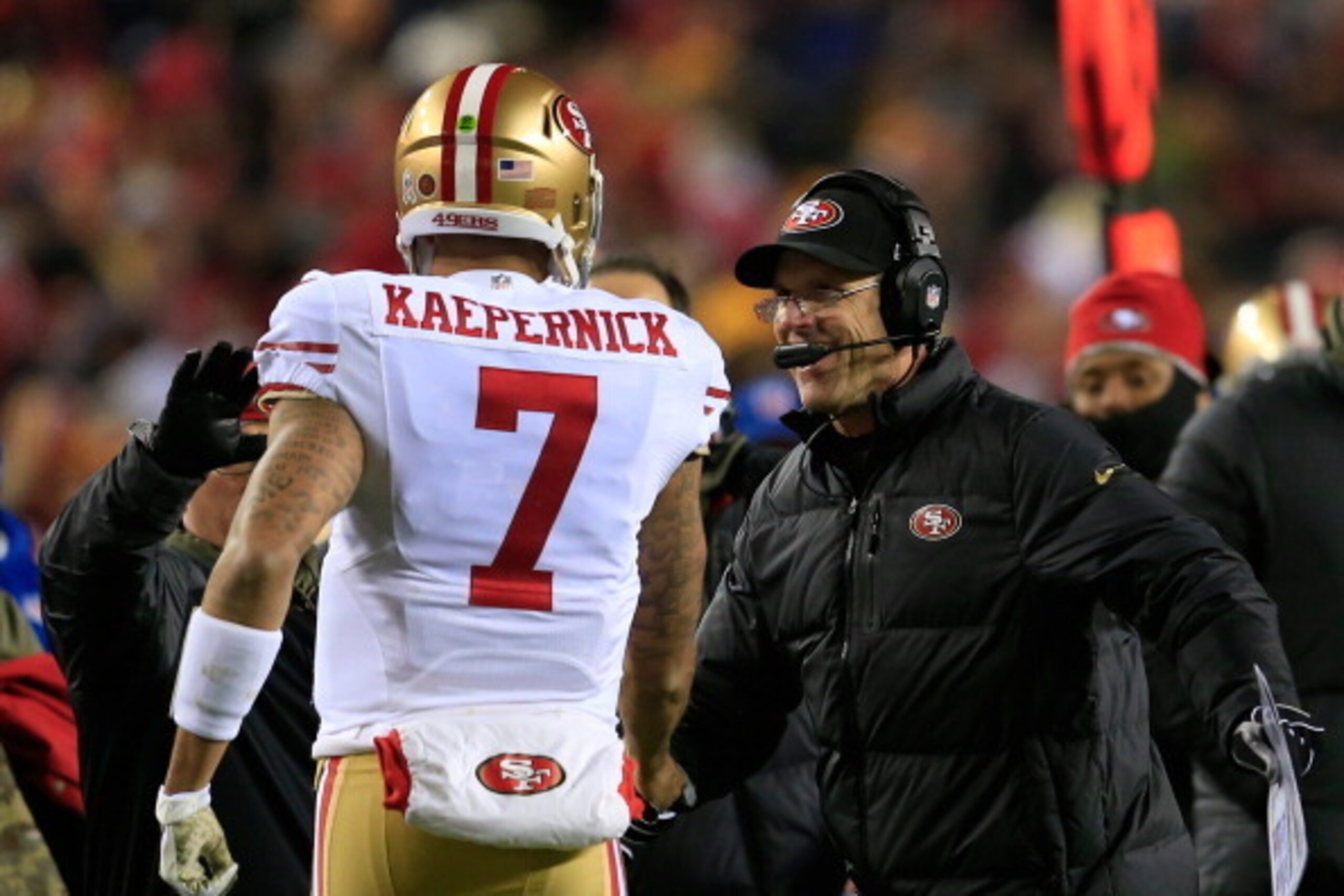 LANDOVER, MD - NOVEMBER 25: Head coach Jim Harbaugh of the San Francisco 49ers celebrates with quarterback Colin Kaepernick #7  after the 49ers scored a third quarter touchdown against the Washington Redskins at FedExField on November 25, 2013 in Landover