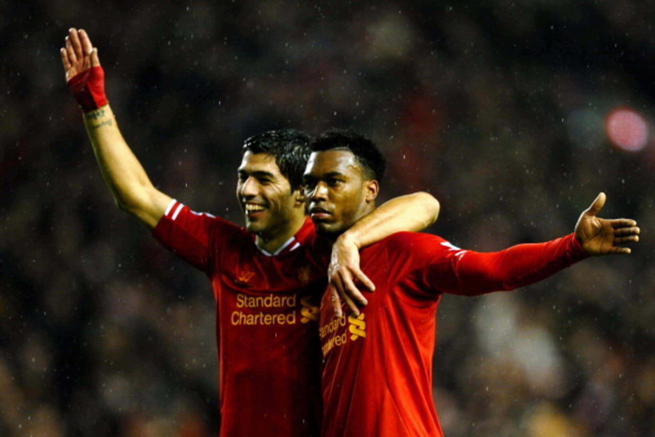 LIVERPOOL, ENGLAND - JANUARY 28:  Daniel Sturridge (R) of Liverpool is congratulated by teammate Luis Suarez (L) after scoring his team's third goal during the Barclays Premier League match between Liverpool and Everton at Anfield on January 28, 2014 in L