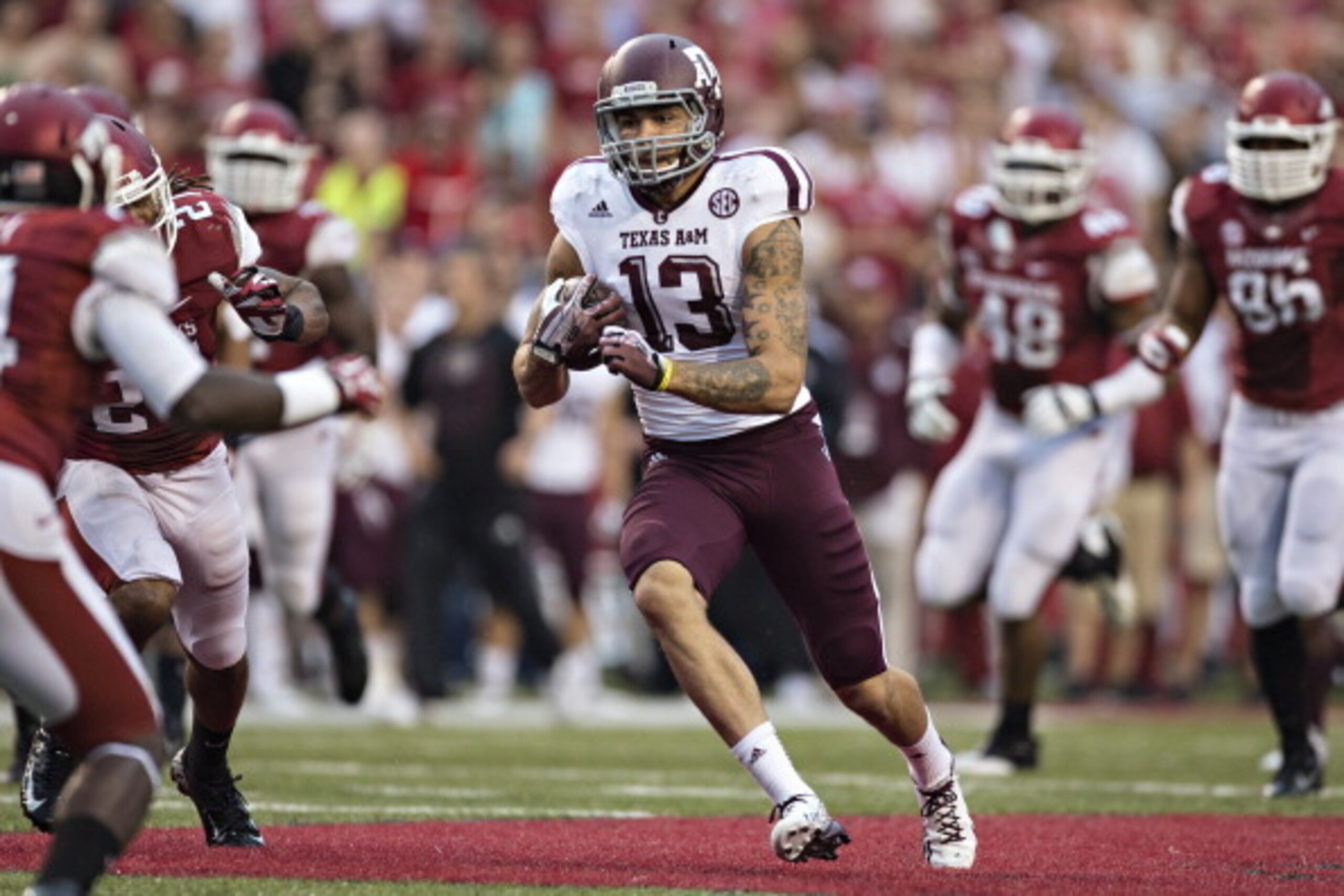 FAYETTEVILLE, AR - SEPTEMBER 28:  Mike Evans #13 of the Texas A&M Aggies runs the ball against the Arkansas Razorbacks at Razorback Stadium on September 28, 2013 in Fayetteville, Arkansas.  The Aggies defeated the Razorbacks 45-33.  (Photo by Wesley Hitt/