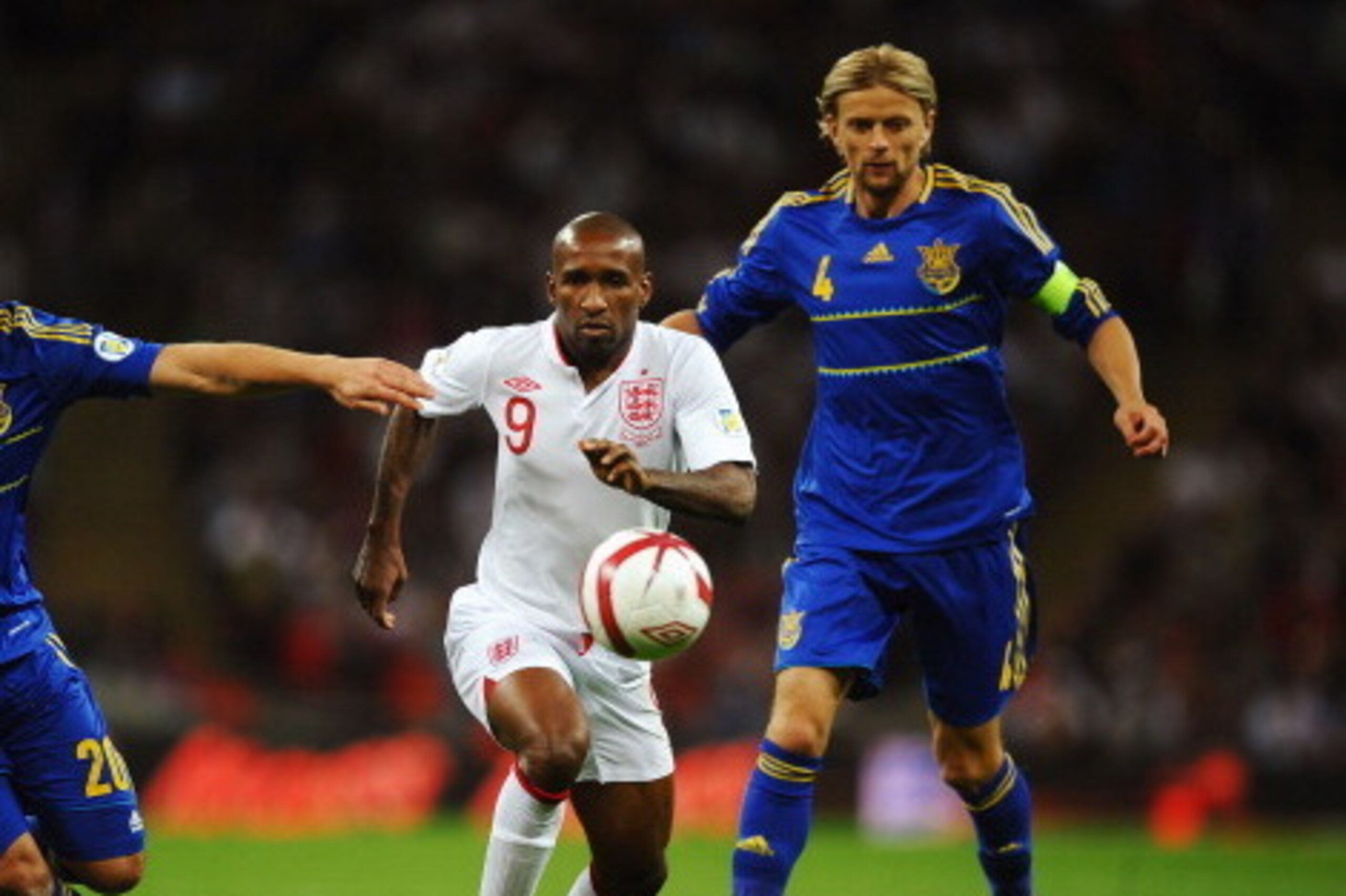 LONDON, ENGLAND - SEPTEMBER 11:  Jermain Defoe (C) of England holds off the challenge of Yaroslav Rakytskiy (L) and Anatoliy Tymoschuk (R) of Ukraine during the FIFA 2014 World Cup Group H qualifying match between England and Ukraine at Wembley Stadium on