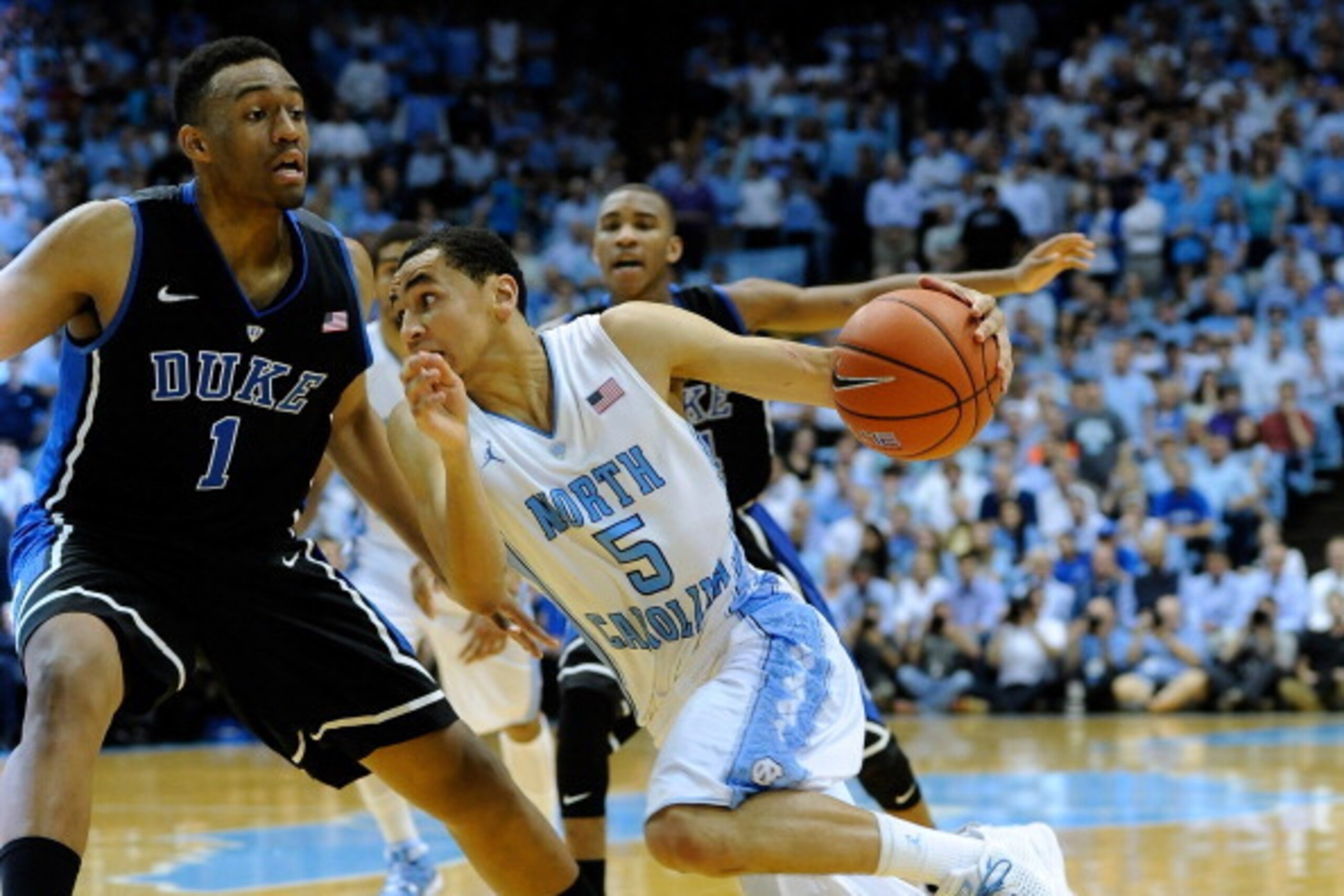 CHAPEL HILL, NC - FEBRUARY 20:  Marcus Paige #5 of the North Carolina Tar Heels drives to the basket against Jabari Parker #1 of the Duke Blue Devils during their game at the Dean Smith Center on February 20, 2014 in Chapel Hill, North Carolina. North Car