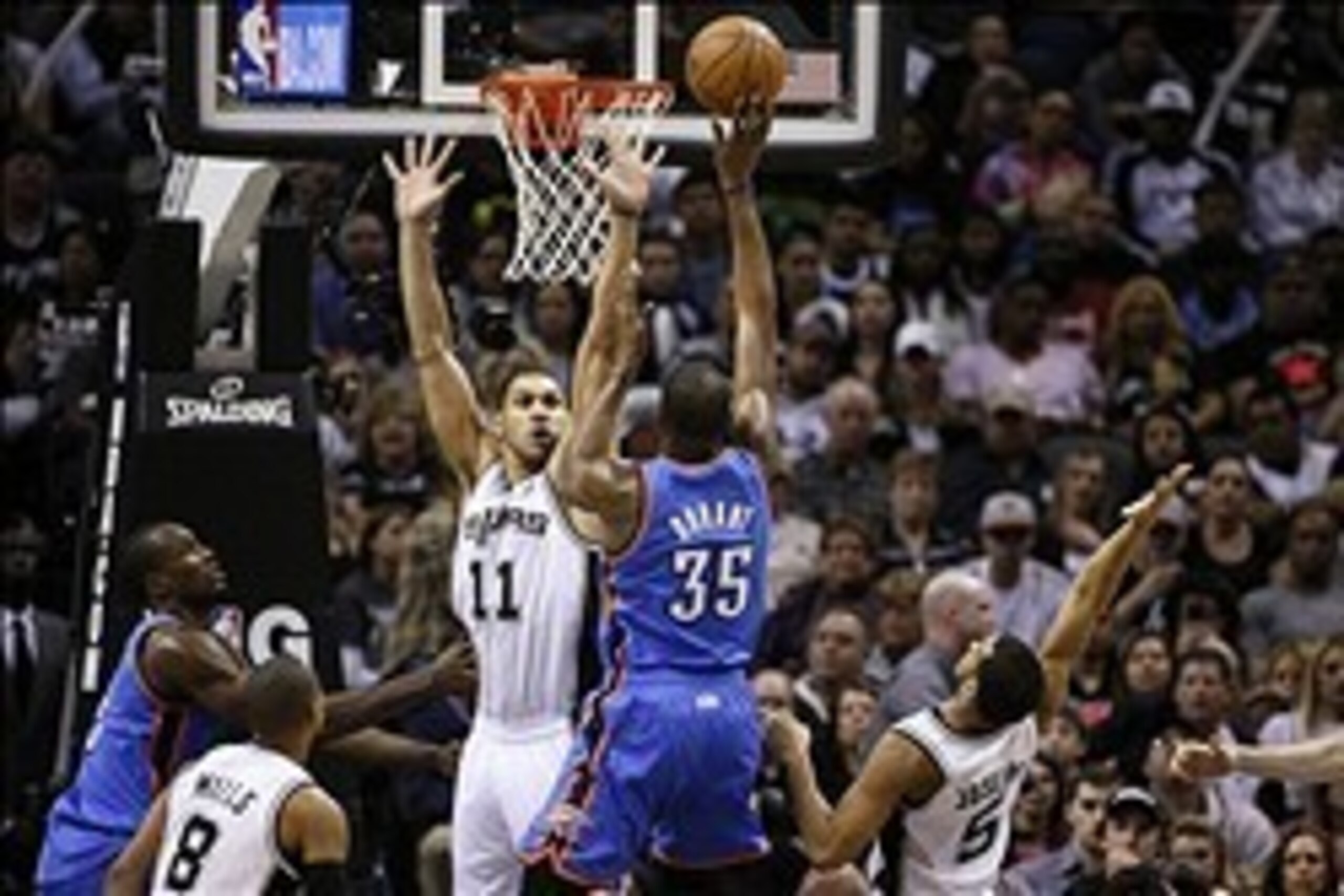 Jan 22, 2014; San Antonio, TX, USA; Oklahoma City Thunder forward Kevin Durant (35) puts up a shot over San Antonio Spurs forward Jeff Ayres (11) during the second half at AT&T Center. The Thunder won 111-105. Mandatory Credit: Soobum Im-USA TODAY Sports