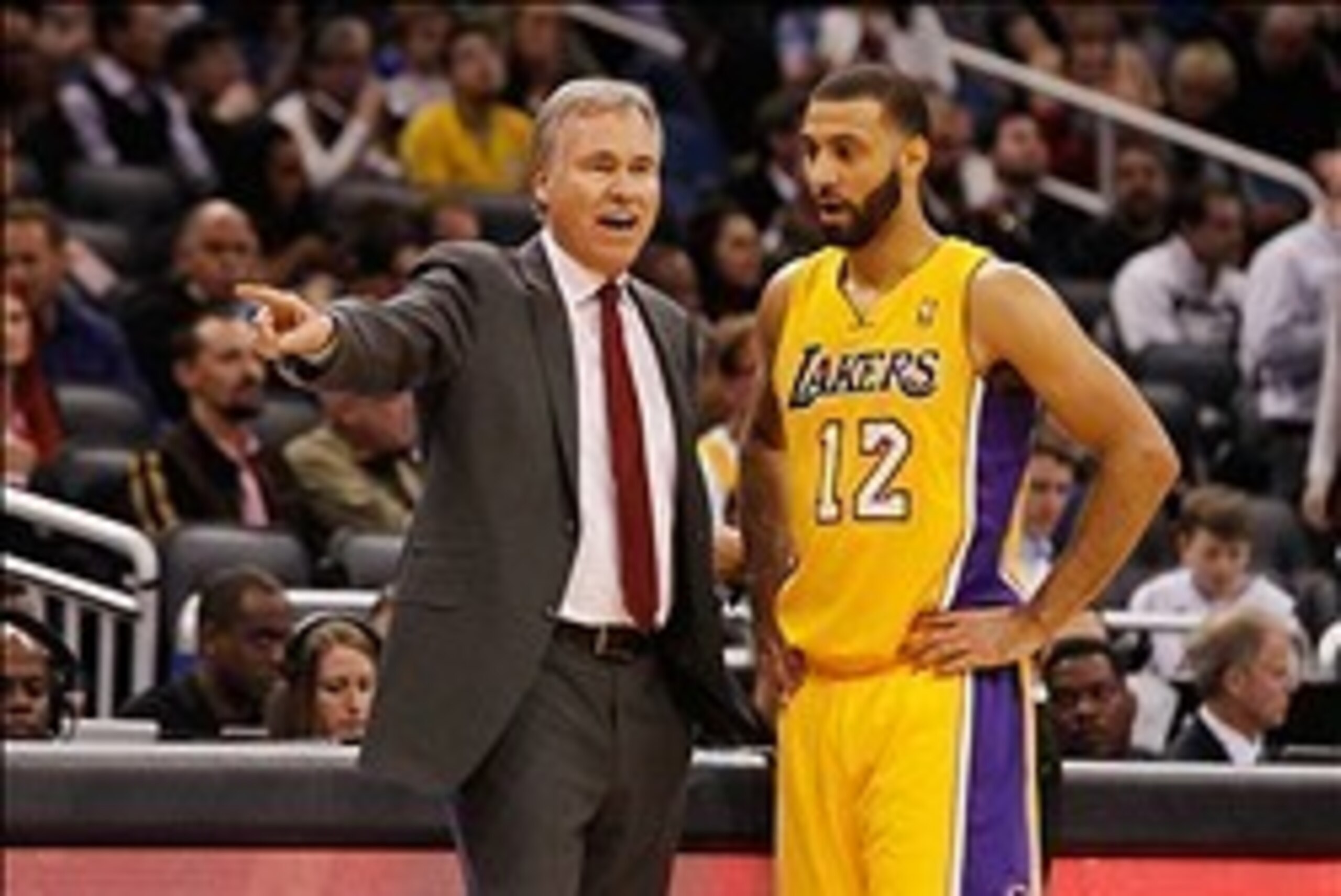 Jan 24, 2014; Orlando, FL, USA; Los Angeles Lakers head coach Mike D'Antoni talks with point guard Kendall Marshall (12) against the Orlando Magic  during the second half at Amway Center. Orlando Magic defeated the Los Angeles Lakers 114-105. Mandatory Cr