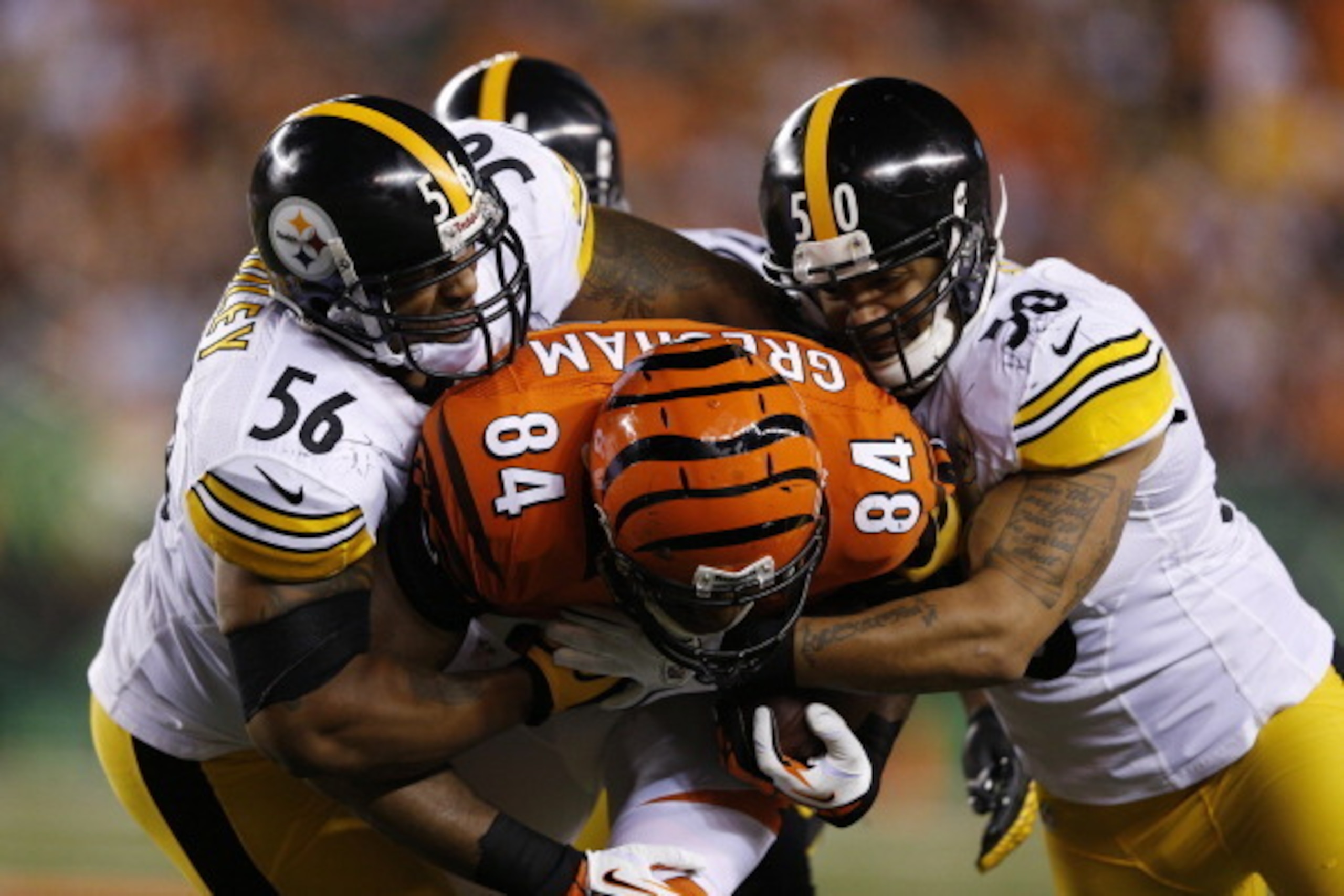 CINCINNATI, OH - OCTOBER 21: LaMarr Woodley #56 and Larry Foote #50 of the Pittsburgh Steelers combine to make a tackle against Jermaine Gresham #84 of the Cincinnati Bengals during the game at Paul Brown Stadium on October 21, 2012 in Cincinnati, Ohio. (