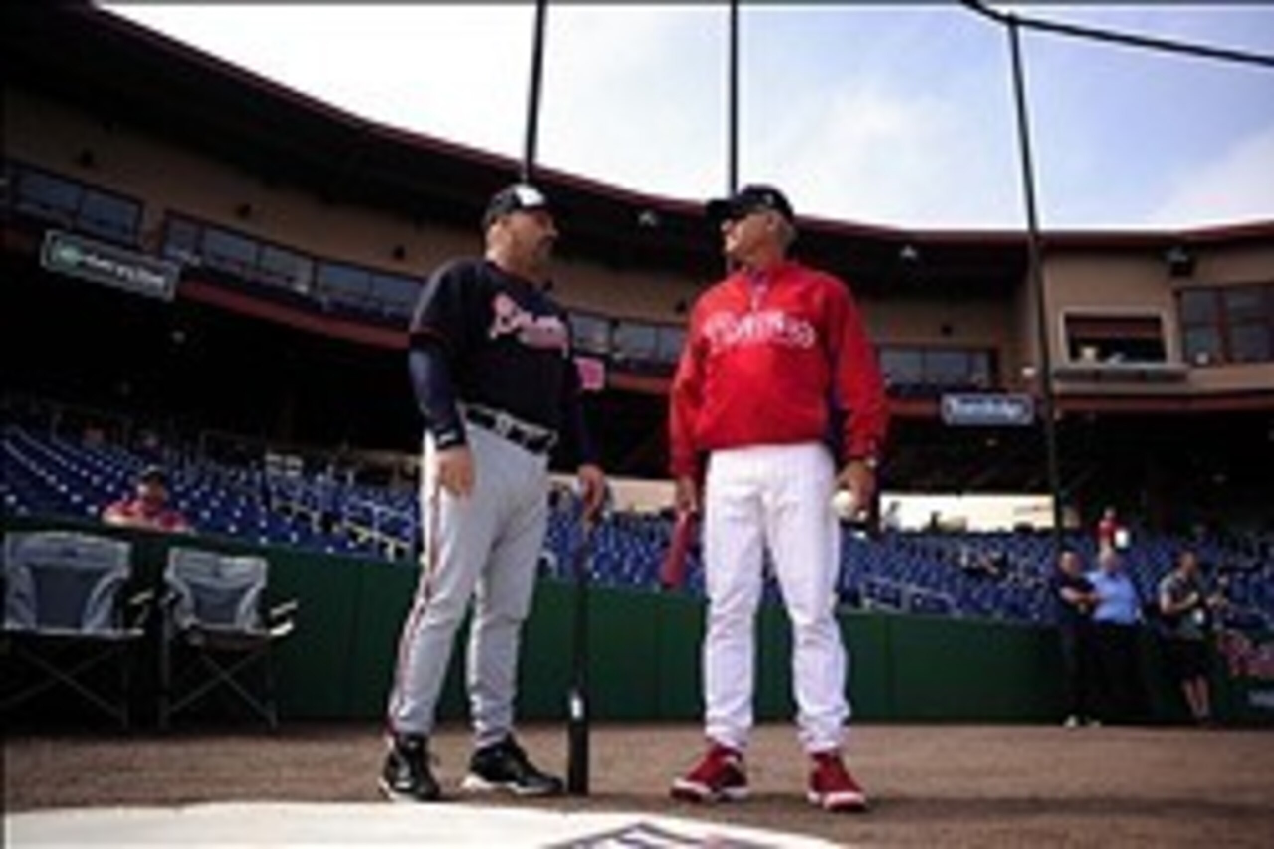 Mar 5, 2014; Clearwater, FL, USA; Atlanta Braves manager Fredi Gonzalez (33) and Philadelphia Phillies manager Ryne Sandberg (23) talk before a spring training exhibition game at Brighthouse Networks Field. Mandatory Credit: David Manning-USA TODAY Sports