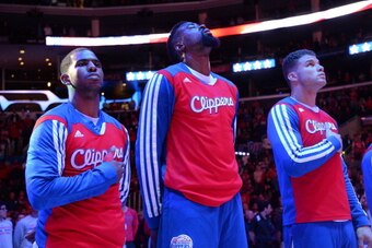 LOS ANGELES, CA - FEBRUARY 26: (L-R) Chris Paul #3, DeAndre Jordan #6, and Blake Griffin #32 of the Los Angeles Clippers stand together during the performance of the National Anthem before facing the Houston Rockets at Staples Center on February 26, 2014 