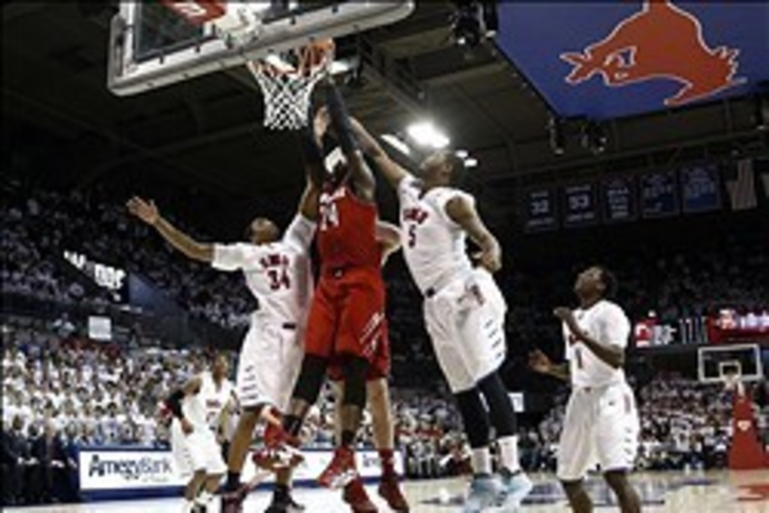 Mar 5, 2014; Dallas, TX, USA; Louisville Cardinals forward Montrezl Harrell (24) shoots against Southern Methodist Mustangs forward Ben Moore (34) and forward Markus Kennedy (5) and guard Ryan Manuel (1) during the first half of a mens basketball game at 