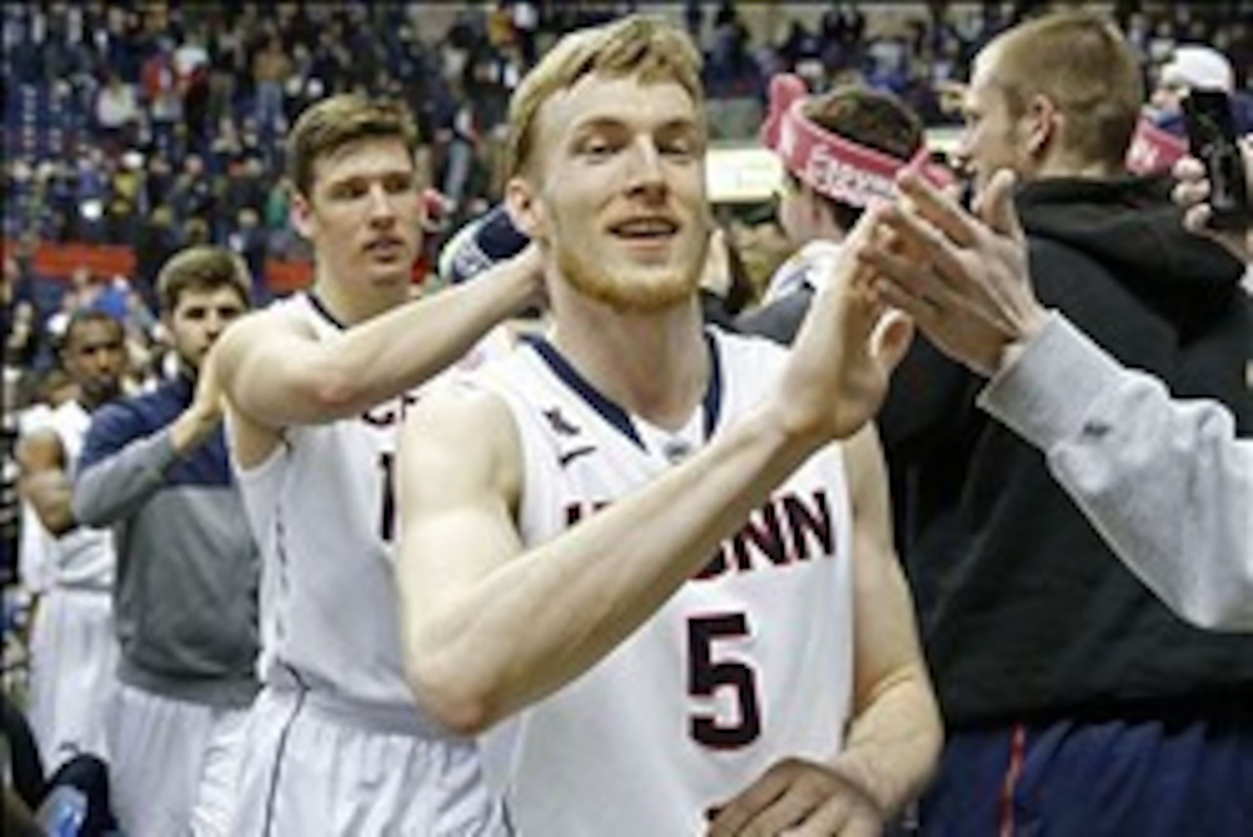 Mar 5, 2014; Storrs, CT, USA; Connecticut Huskies guard/forward Niels Giffey (5) and forward Tyler Olander (10)  exit the court after the game against the Rutgers Scarlet Knights at Harry A. Gampel Pavilion. UConn defeated Rutgers 69-63. Mandatory Credit: