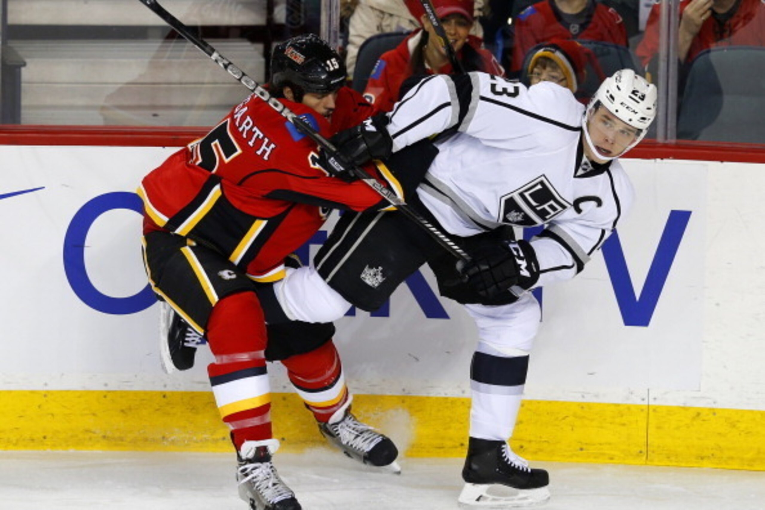 CALGARY, CANADA - FEBRUARY 27: Kevin Westgarth (L) of the Calgary Flames pushes Dustin Brown of the Los Angeles Kings away from the puck during the first period of their NHL hockey game at the Scotiabank Saddledome February 27, 2014 in Calgary, Alberta, C CALGARY, CANADA - FEBRUARY 27: Kevin Westgarth (L) of the Calgary Flames pushes Dustin Brown of the Los Angeles Kings away from the puck during the first period of their NHL hockey game at the Scotiabank Saddledome February 27, 2014 in Calgary, Alberta, C