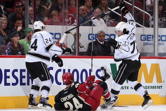 GLENDALE, AZ - JANUARY 28: Jordan Nolan #71 of the Los Angeles Kings lays a body check onto Kyle Chipchura #24 of the Phoenix Coyotes during the second period of the NHL game at Jobing.com Arena on January 29, 2014 in Glendale, Arizona. (Photo by Christ GLENDALE, AZ - JANUARY 28: Jordan Nolan #71 of the Los Angeles Kings lays a body check onto Kyle Chipchura #24 of the Phoenix Coyotes during the second period of the NHL game at Jobing.com Arena on January 29, 2014 in Glendale, Arizona. (Photo by Christ
