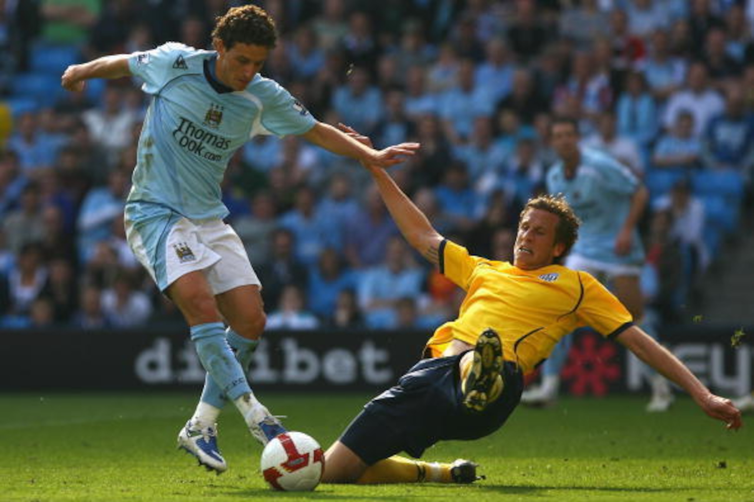 MANCHESTER, ENGLAND - APRIL 19:  Elano of Manchester City is tackled by Jonas Olsson of West Bromwich Albion to concede a penalty during the Barclays Premier League match between Manchester City and West Bromwich Albion at the City of Manchester Stadium o