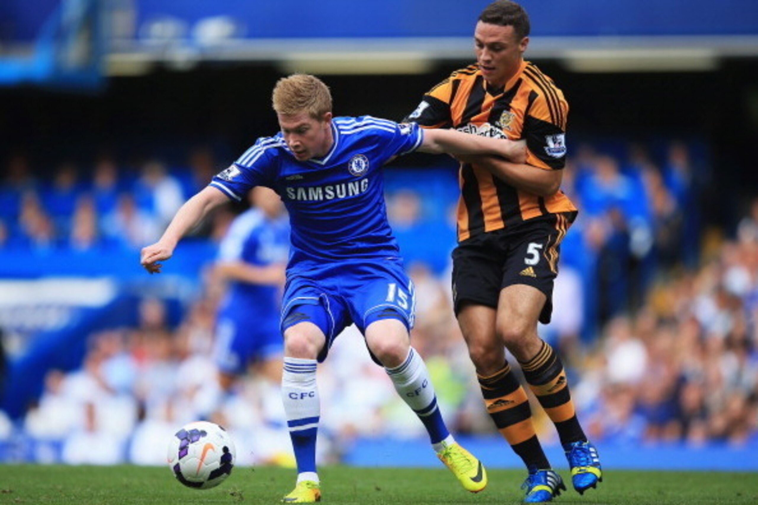 LONDON, ENGLAND - AUGUST 18: Kevin De Bruyne of Chelsea is challenged by James Chester of Hull City during the Barclays Premier League match between Chelsea and Hull City at Stamford Bridge on August 18, 2013 in London, England. (Photo by Richard Heathc LONDON, ENGLAND - AUGUST 18: Kevin De Bruyne of Chelsea is challenged by James Chester of Hull City during the Barclays Premier League match between Chelsea and Hull City at Stamford Bridge on August 18, 2013 in London, England. (Photo by Richard Heathc