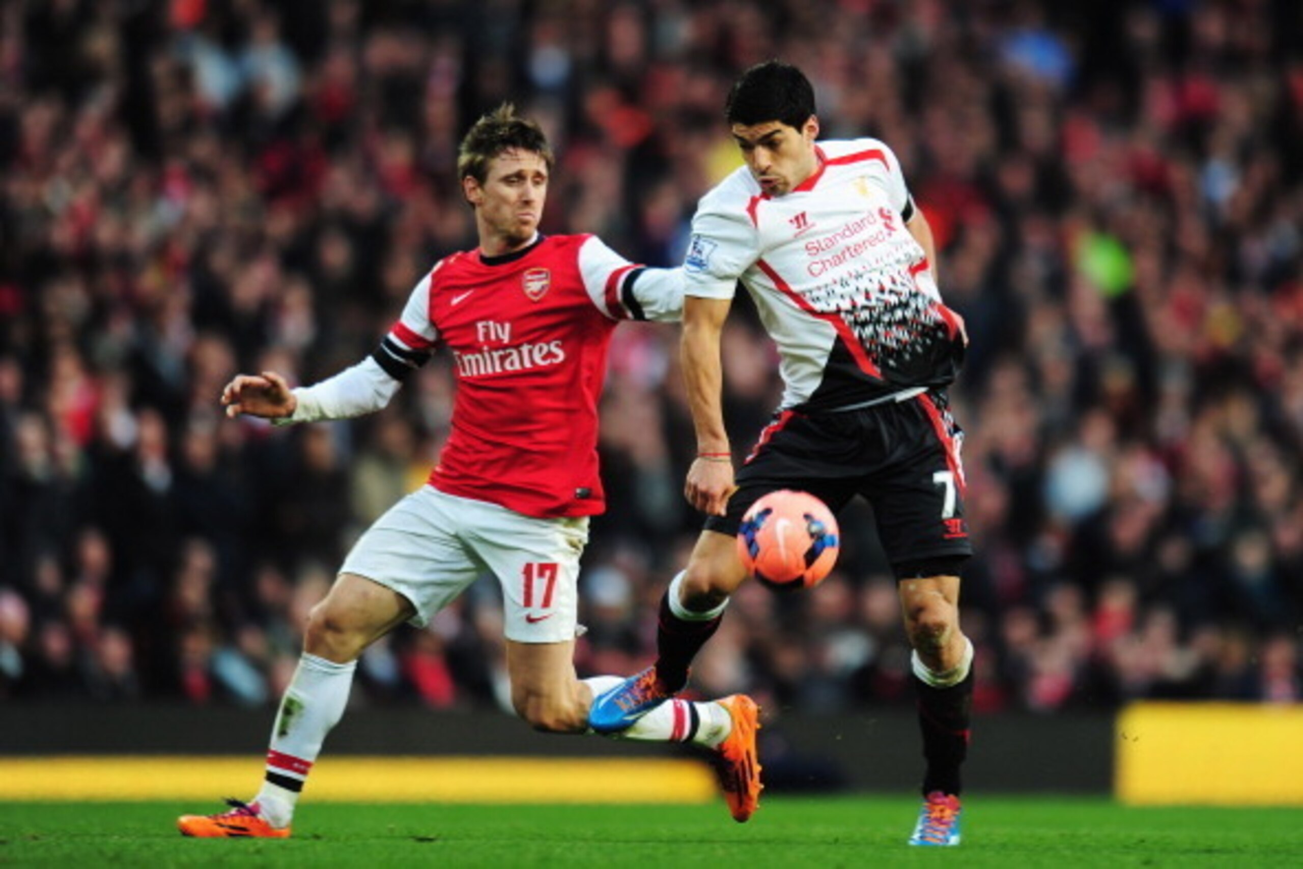 LONDON, ENGLAND - FEBRUARY 16: (L-R) Nacho Monreal of Arsenal and Luis Suarez of Liverpool challenge for the ball during the FA Cup Fifth Round match between Arsenal and Liverpool at the Emirates Stadium on February 16, 2014 in London, England. (Photo b LONDON, ENGLAND - FEBRUARY 16: (L-R) Nacho Monreal of Arsenal and Luis Suarez of Liverpool challenge for the ball during the FA Cup Fifth Round match between Arsenal and Liverpool at the Emirates Stadium on February 16, 2014 in London, England. (Photo b