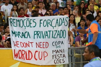 RIO DE JANEIRO, BRAZIL - JUNE 20:  Protestors display banners during the FIFA Confederations Cup Brazil 2013 Group B match between Spain and Tahiti at the Maracana Stadium on June 20, 2013 in Rio de Janeiro, Brazil.  (Photo by Ronald Martinez/Getty Images