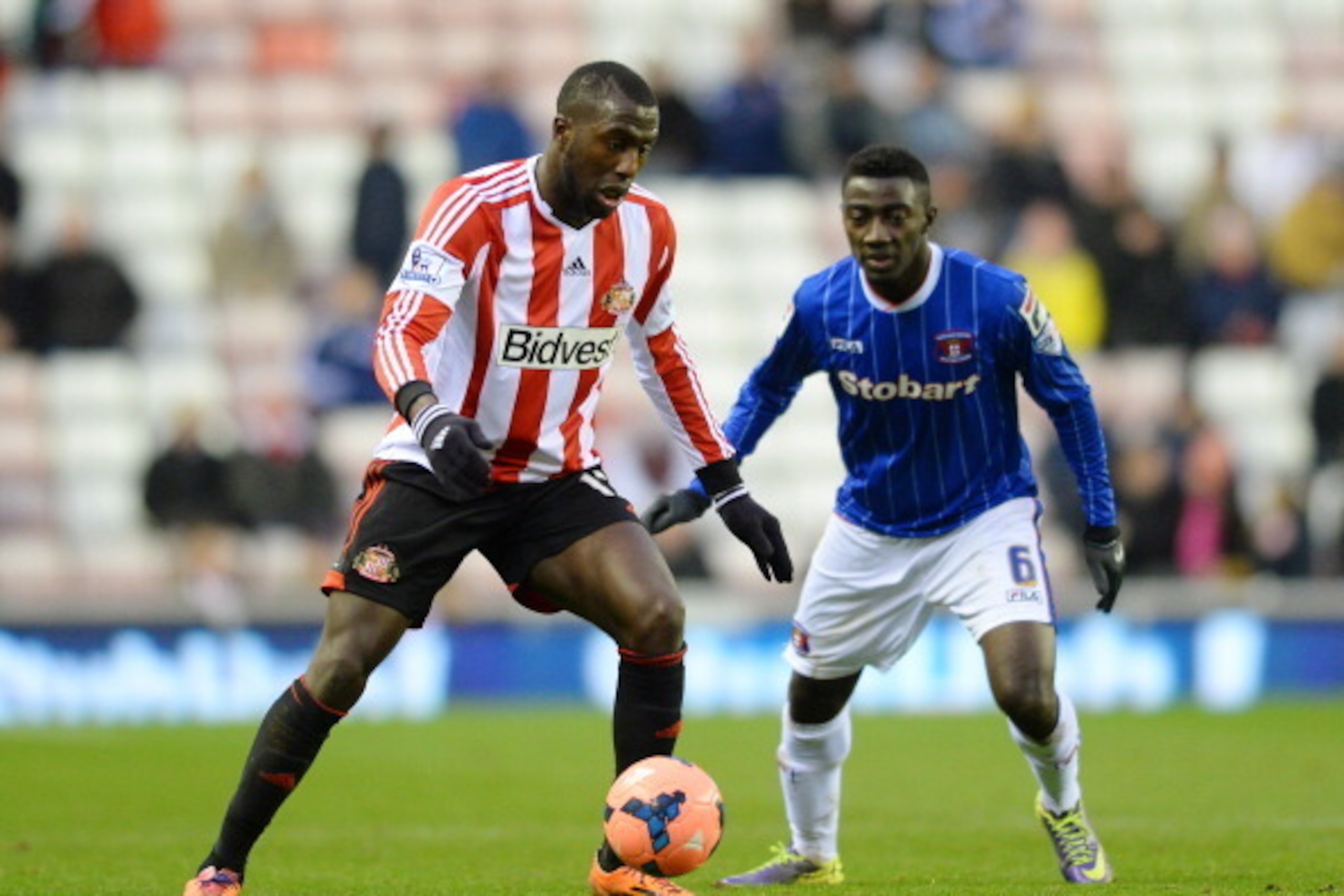 SUNDERLAND, ENGLAND - JANUARY 05:  Jozy Altidore of Sunderland is closed down by Prince Buaben of Carlisle during the Budweiser FA Cup third round match between Sunderland and Carlisle United at the Stadium of Light on January 5, 2014 in Sunderland, Engla