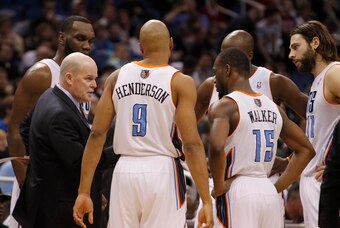 Jan 17, 2014; Orlando, FL, USA; Charlotte Bobcats head coach Steve Clifford huddles up with shooting guard Gerald Henderson (9), point guard Kemba Walker (15) and teammates against the Orlando Magic during the second half at Amway Center. Charlotte Bobcat
