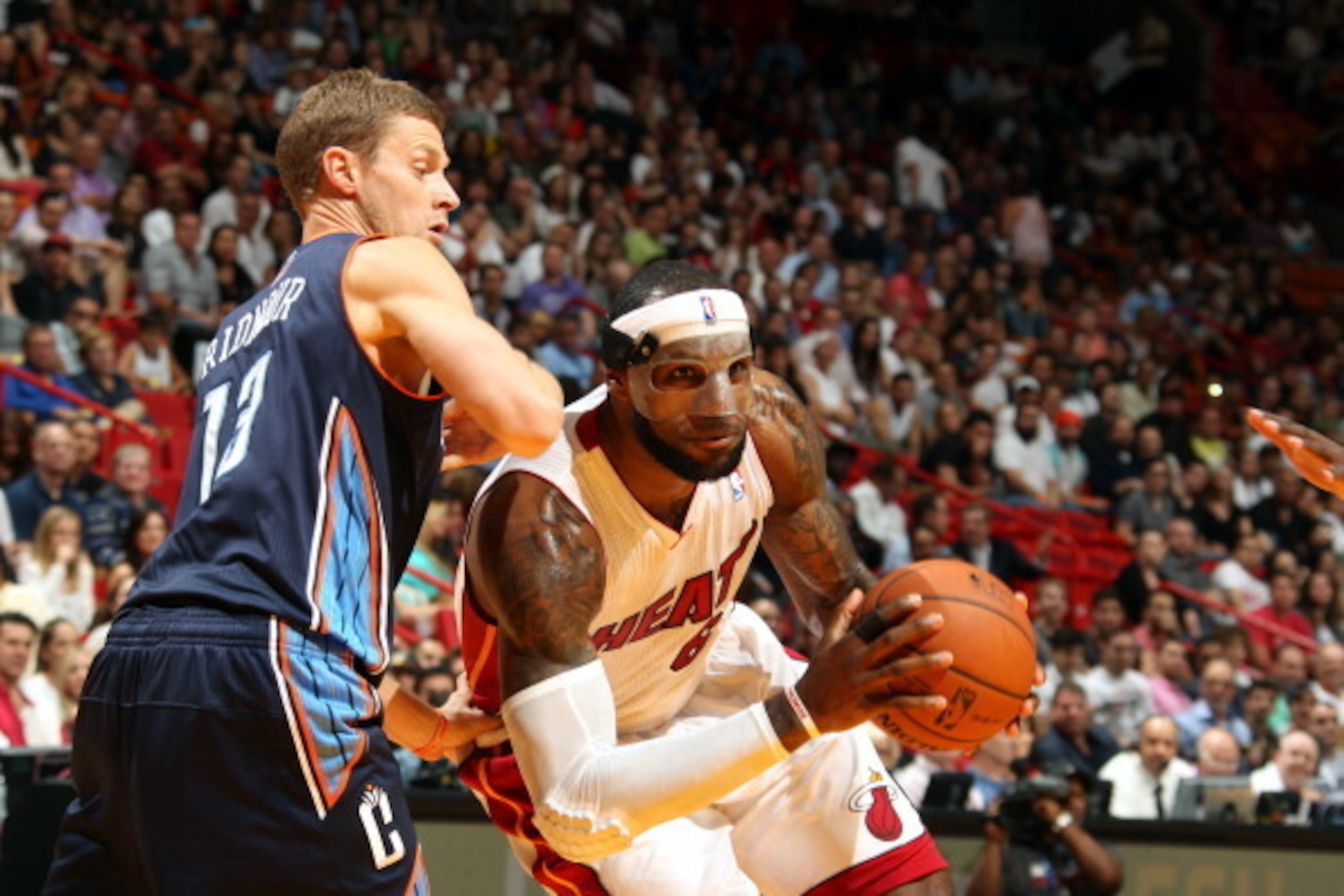 MIAMI, FL - MARCH 3:  LeBron James #6 of the Miami Heat drives to the basket against Luke Ridnour #13 of the Charlotte Bobcats at the American Airlines Arena in Miami, Florida on Mar. 3, 2014. NOTE TO USER: User expressly acknowledges and agrees that, by 