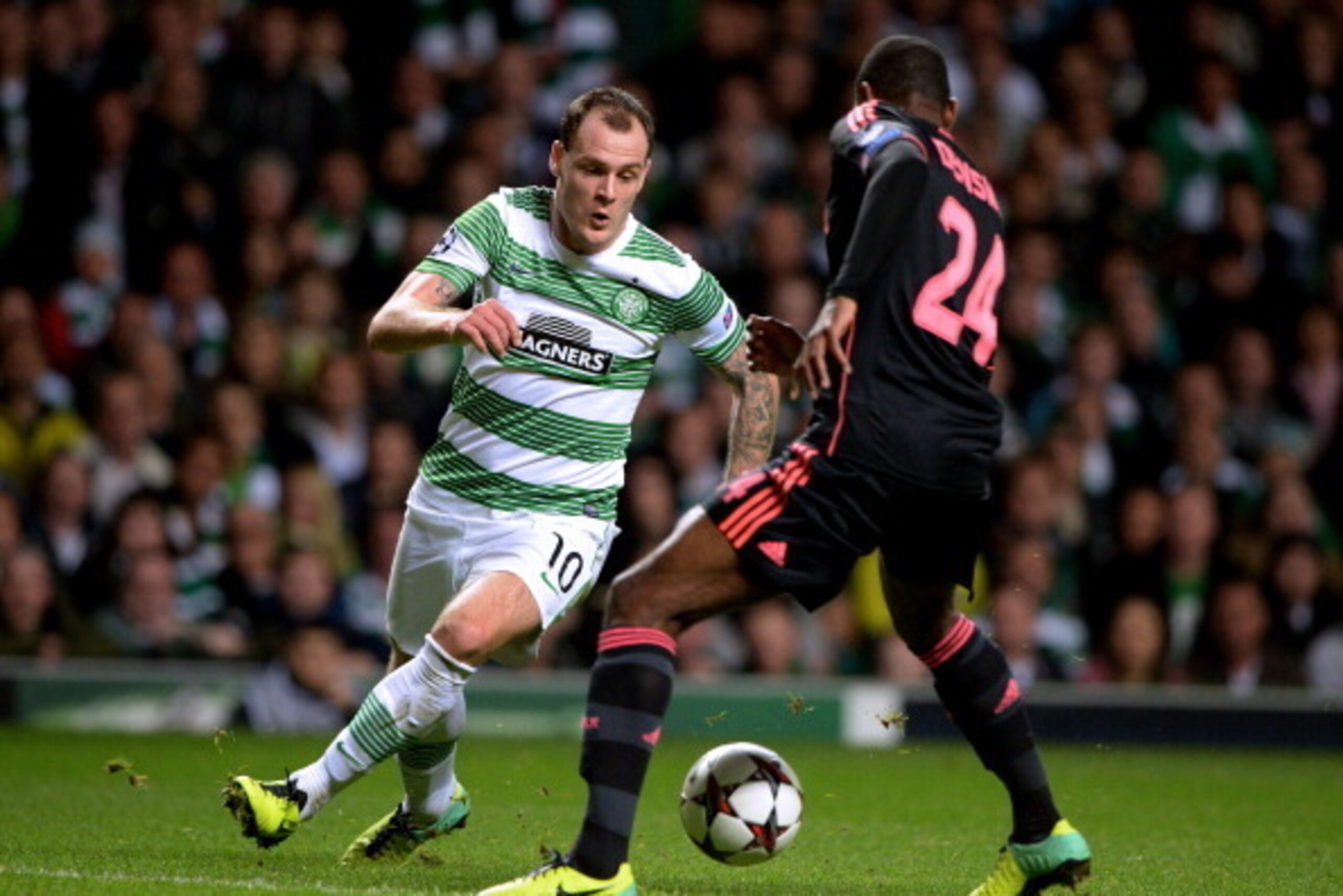 GLASGOW, SCOTLAND - OCTOBER 22:  Anthony Stokes of Celtic takes on Stefano Denswil of Ajax during the UEFA Champions League Group H match between Celtic and Ajax at Celtic Park Stadium on October 22, 2013 in Glasgow, Scotland.  (Photo by Jeff J Mitchell/G