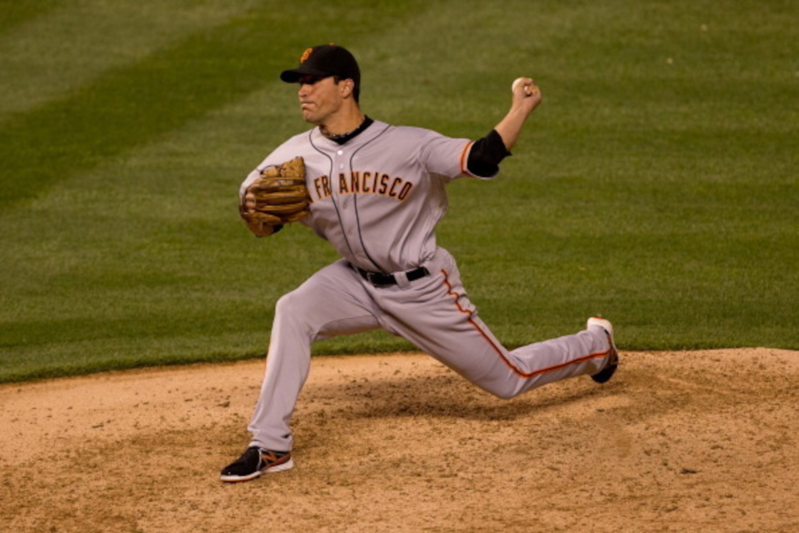 DENVER, CO - AUGUST 27:  Javier Lopez #49 of the San Francisco Giants delivers to home plate during the eighth inning against the Colorado Rockies at Coors Field on August 27, 2013 in Denver, Colorado.  The Giants defeated the Rockies 5-3.  (Photo by Just