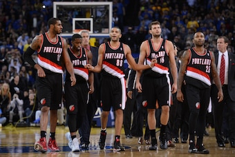 November 23, 2013; Oakland, CA, USA; Portland Trail Blazers small forward Nicolas Batum (88) leads power forward LaMarcus Aldridge (12), shooting guard Wesley Matthews (2), center Joel Freeland (19), and point guard Mo Williams (25) to their bench after a