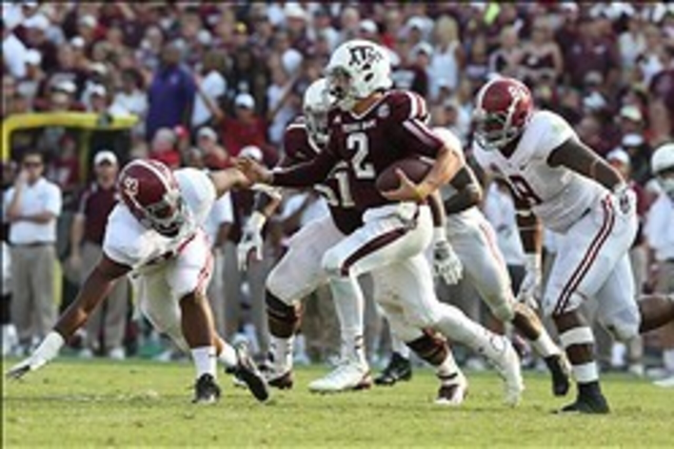 Sep 14, 2013; College Station, TX, USA; Texas A&M Aggies  quarterback Johnny Manziel (2) scrambles in the fourth quarter against Alabama Crimson Tide defensive end Jonathan Allen (93) and Jeoffrey Pagan (8) at Kyle Field. Alabama Crimson Tide beat the Tex