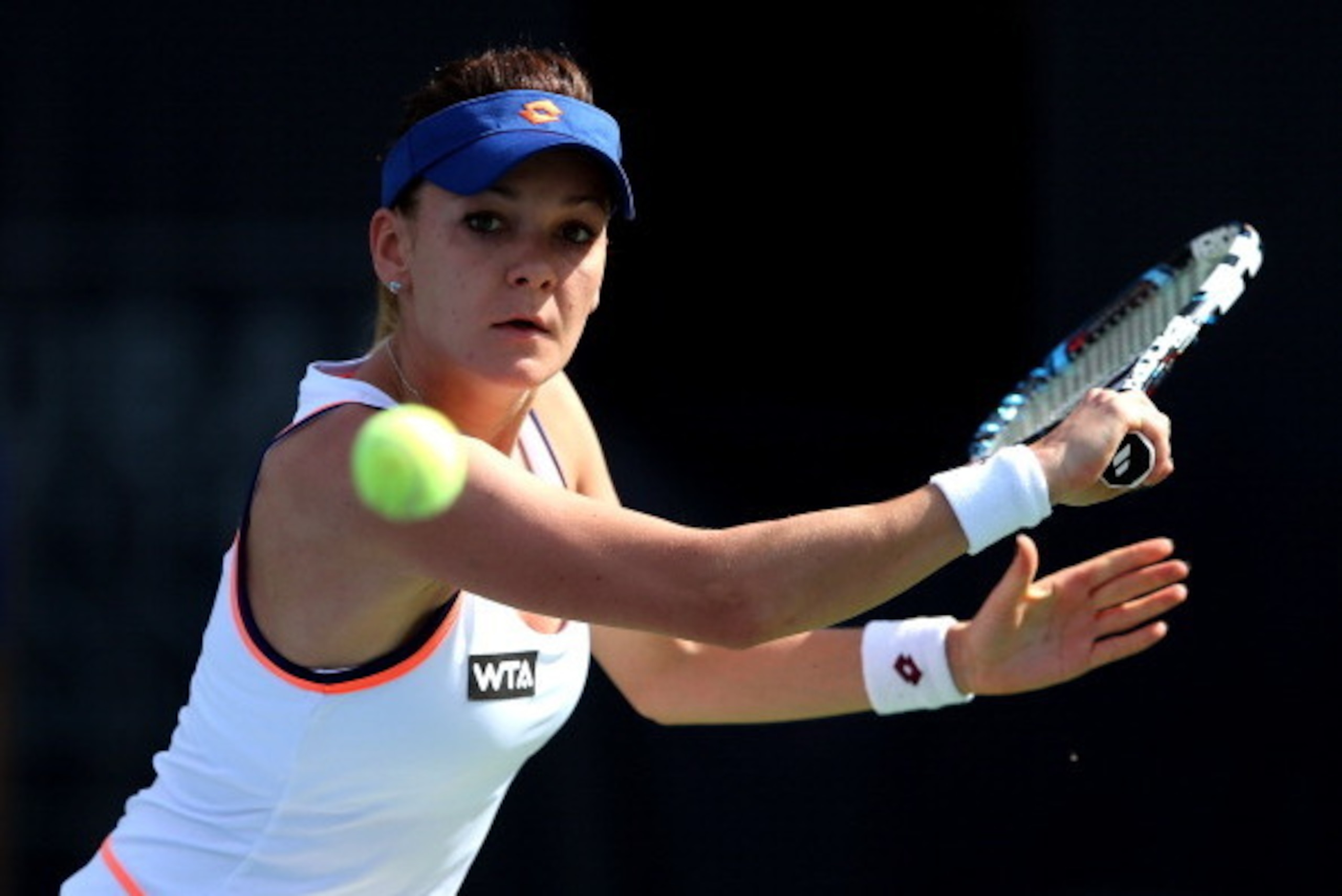 DUBAI, UNITED ARAB EMIRATES - FEBRUARY 19:  Agnieszka Radwanska of Poland in action against Flavia Pennetta of Italy during day three of the WTA Dubai Duty Free Tennis Championship at the Dubai Tennis Stadium on February 19, 2014 in Dubai, United Arab Emi