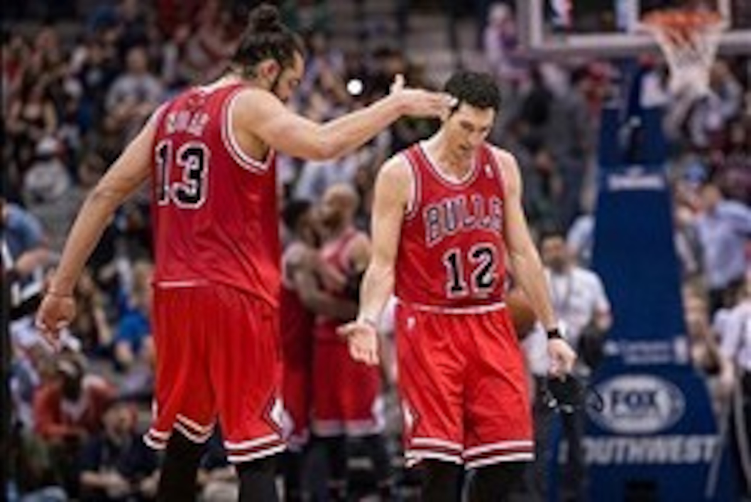 Feb 28, 2014; Dallas, TX, USA; Chicago Bulls center Joakim Noah (13) and shooting guard Kirk Hinrich (12) celebrate the win over the Dallas Mavericks at the American Airlines Center. The Bulls defeated the Mavericks 100-91. Mandatory Credit: Jerome Miron-