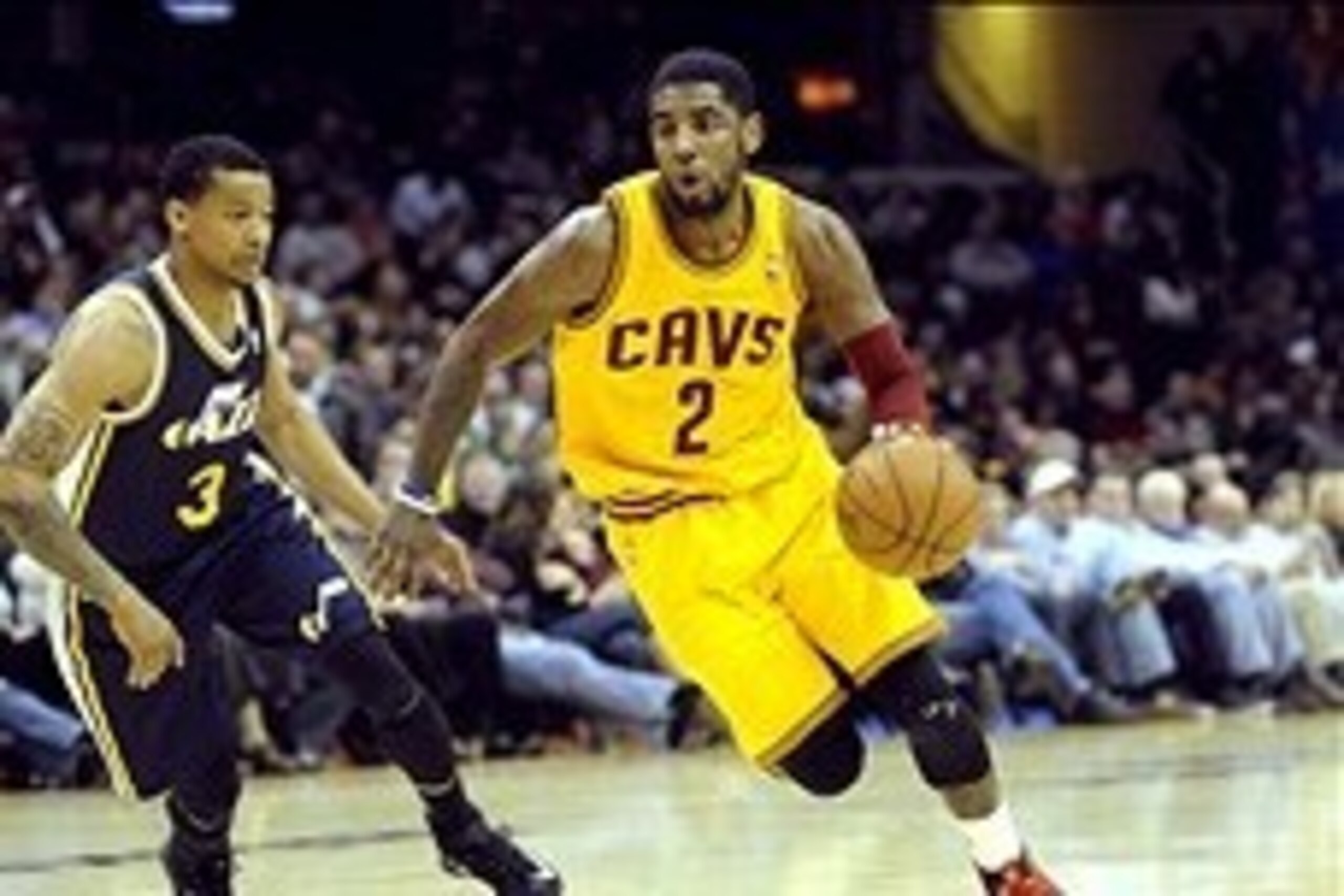 Feb 28, 2014; Cleveland, OH, USA; Cleveland Cavaliers point guard Kyrie Irving (2) drives past Utah Jazz point guard Trey Burke (3) during the second quarter at Quicken Loans Arena. The Cavaliers beat the Jazz 99-79. Mandatory Credit: Ken Blaze-USA TODAY 