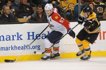 BOSTON, MA - MARCH 4: Marcel Goc #57 of the Florida Panthers skates against Torey Krug #47 of the Boston Bruins at the TD Garden on March 4, 2014 in Boston, Massachusetts.  (Photo by Steve Babineau/NHLI via Getty Images)