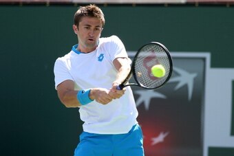 INDIAN WELLS, CA - MARCH 06:  Tim Smyczek hits a return to Jack Sock during the BNP Paribas Open at Indian Wells Tennis Garden on March 6, 2014 in Indian Wells, California.  (Photo by Stephen Dunn/Getty Images)