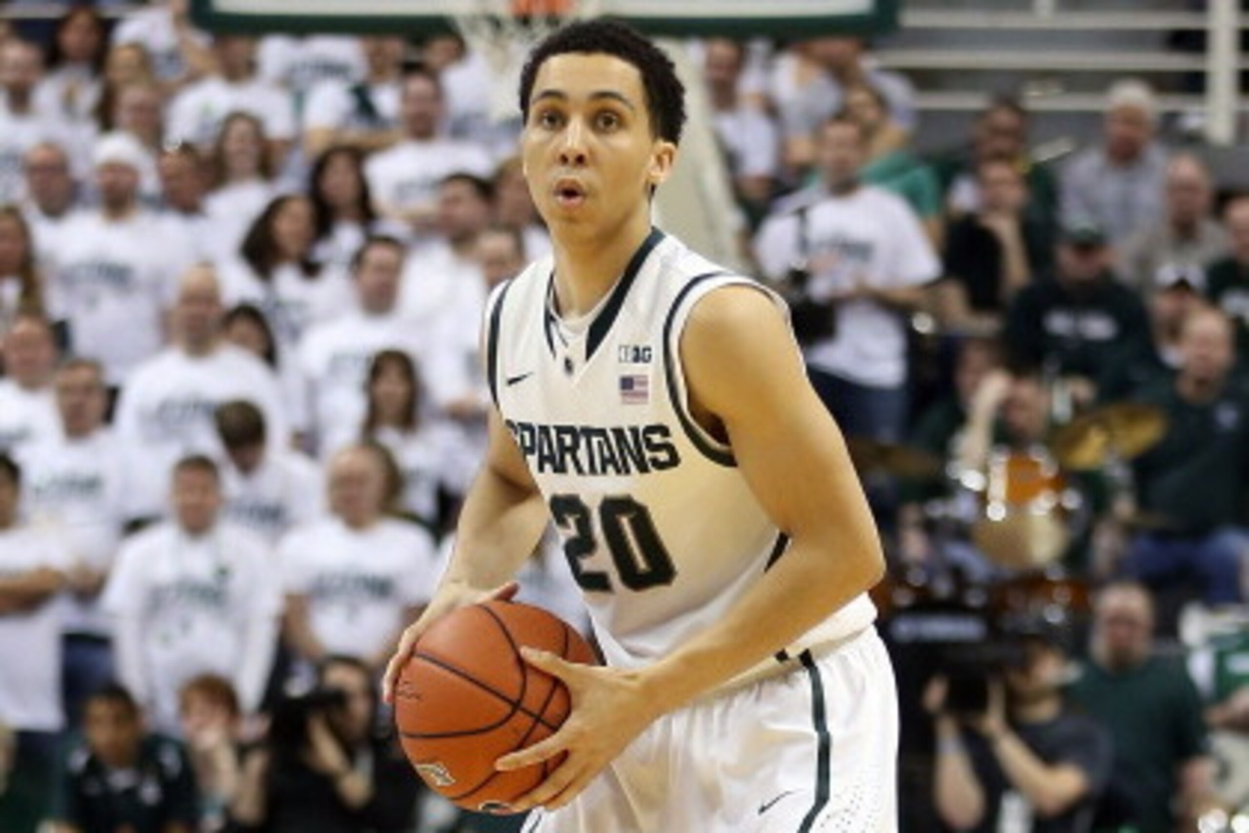 EAST LANSING, MI - MARCH 01:  Travis Trice #20 of the Michigan State Spartans brings the basketball up the court during the second half of the game against the University of Illinois at the Breslin Center on March 1, 2014 in East Lansing, Michigan. Illino