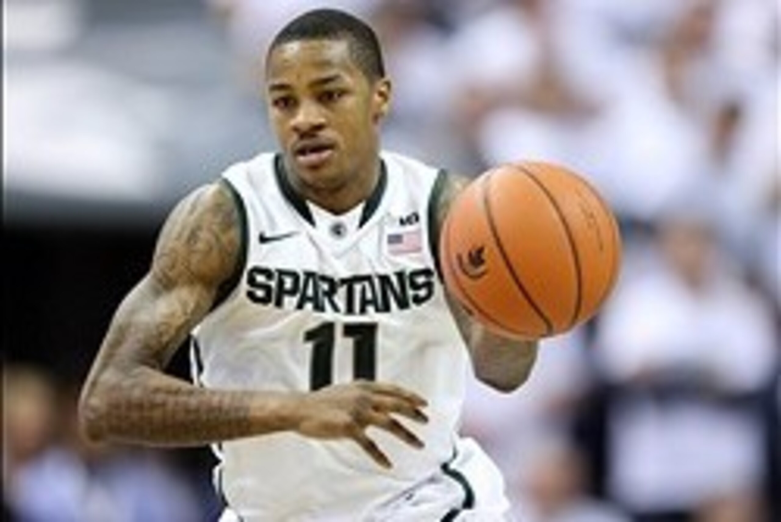 Mar 1, 2014; East Lansing, MI, USA; Michigan State Spartans guard Keith Appling (11) brings the ball up court against the Illinois Fighting Illini during the 2nd half of a game at Jack Breslin Student Events Center. Illinois won 53-46. Mandatory Credit: M