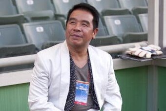 HONG KONG, CHINA - JULY 18:  Hong Kong billonaire Carson Yeung, owner of Birmingham City sits on the bench before the Xtep Cup against Hong Kong League XI as part of Birmingham City's China pre-season tour at the Hong Kong stadium on July 18, 2010 in Hong
