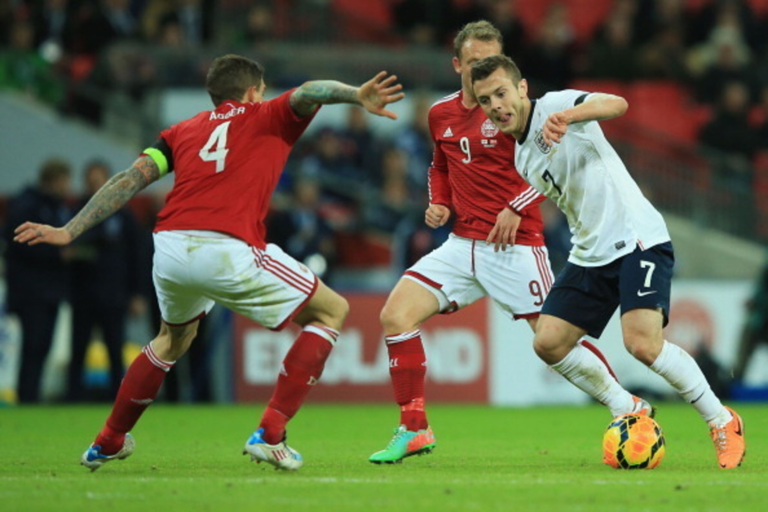 LONDON, ENGLAND - MARCH 05:  Jack Wilshere of England takes on Daniel Agger of Denmark during the International Friendly match between England and Denmark at Wembley Stadium on March 5, 2014 in London, England.  (Photo by Richard Heathcote/Getty Images)
