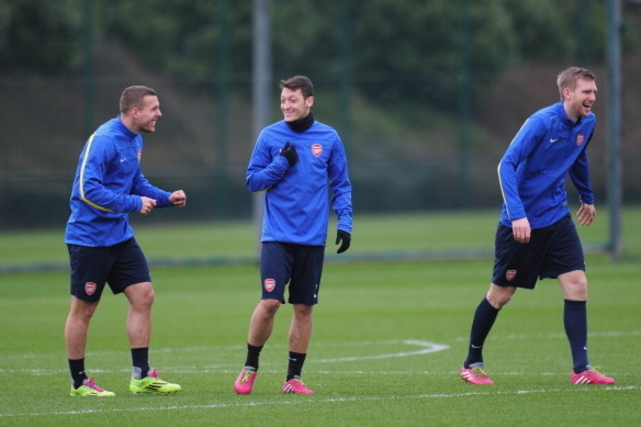 ST ALBANS, ENGLAND - FEBRUARY 18:  Per Mertesacker, Mesut Ozil and Lukas Podolski of Arsenal warm up during a training session at London Colney on February 18, 2014 in St Albans, England.  (Photo by Shaun Botterill/Getty Images)