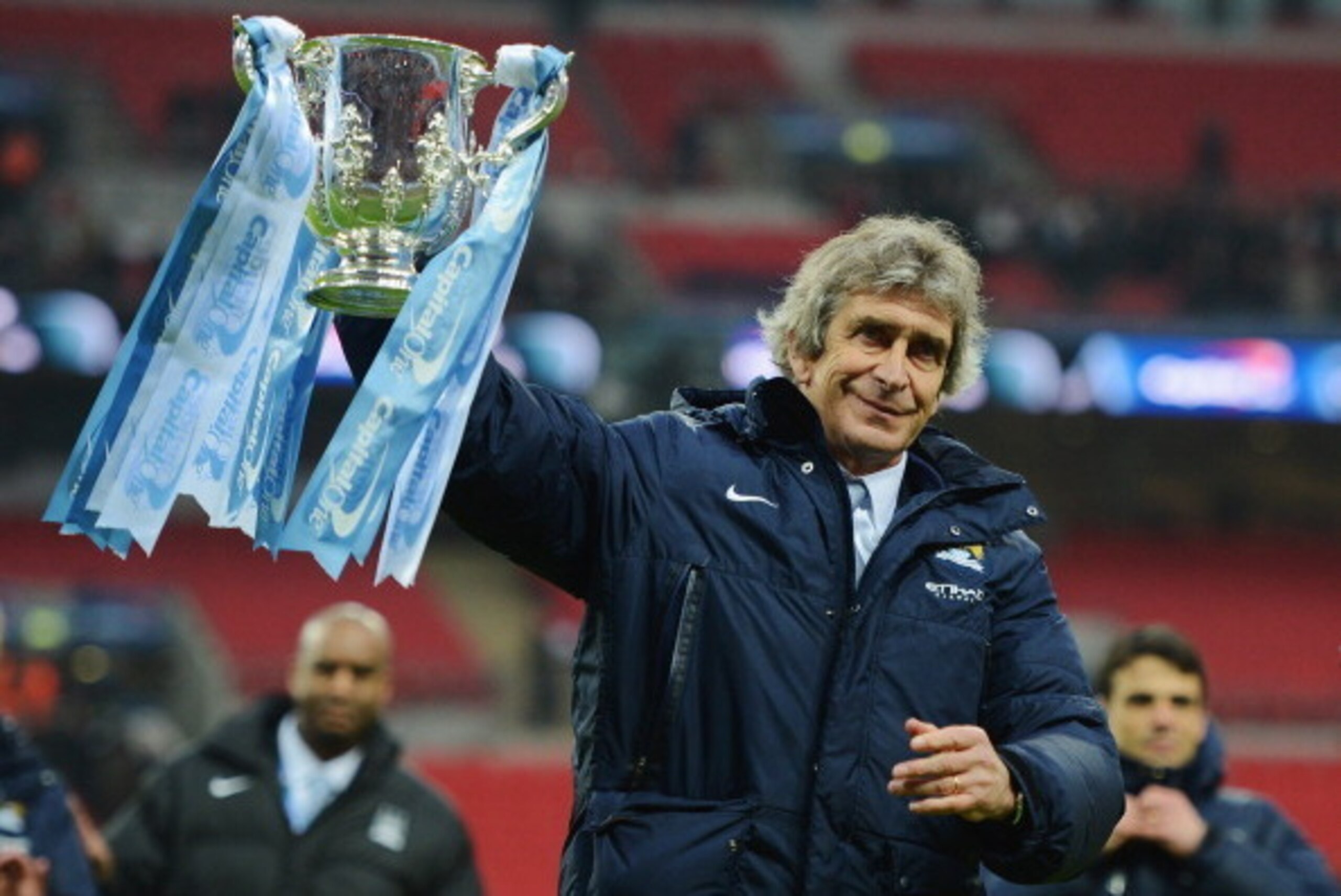 LONDON, ENGLAND - MARCH 02: Manuel Pellegrini, manager of Manchester City celebrates victory with the trophy after the Capital One Cup Final between Manchester City and Sunderland at Wembley Stadium on March 2, 2014 in London, England.  (Photo by Michael 
