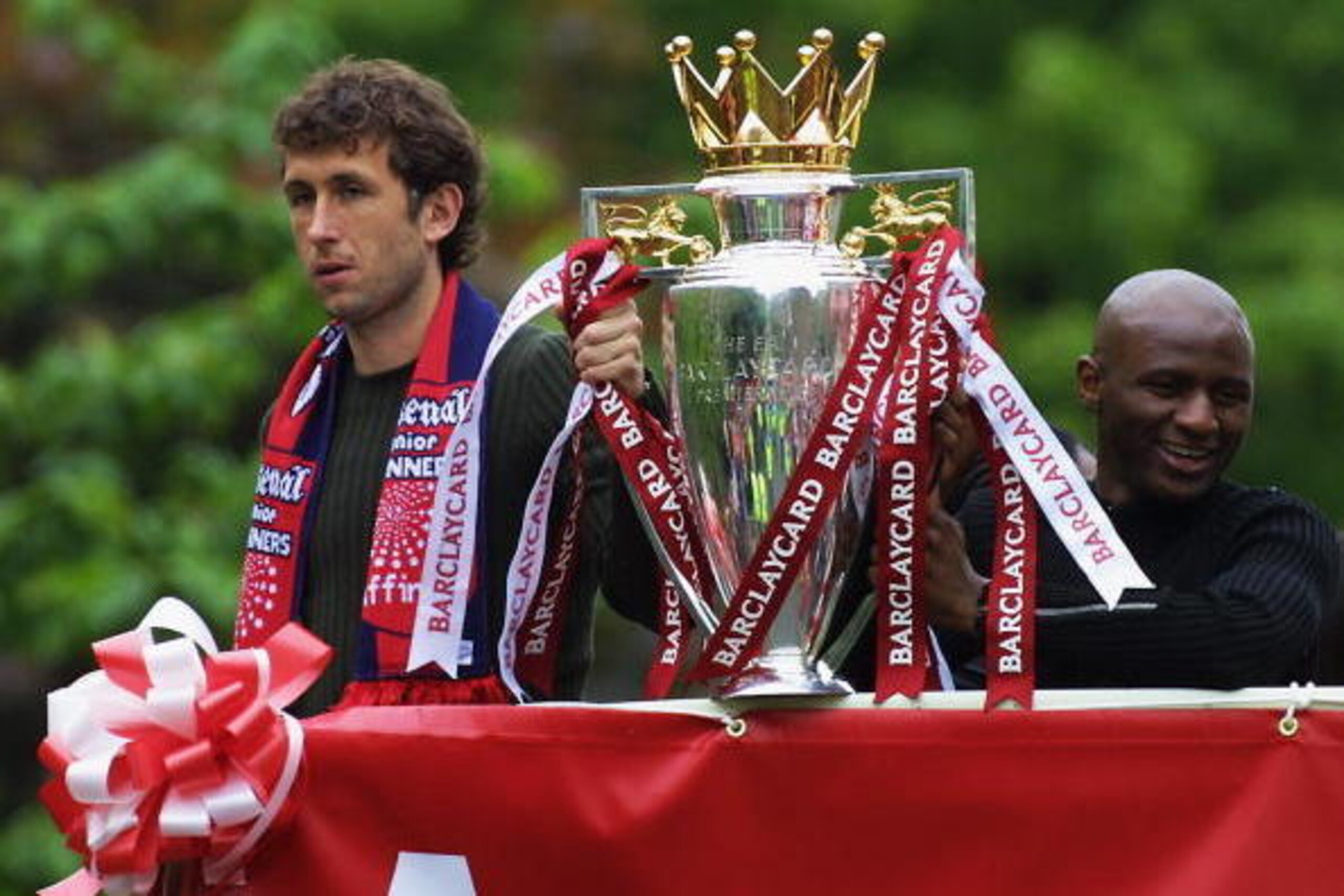 LONDON -  MAY 12:  Gilles Grimandi and Patrick Vieira of Arsenal with the FA Barclaycard Premiership trophy  during Arsenal's open top bus parade of the AXA FA Cup and the FA Barclaycard Premiership trophy to their fans held on May 12, 2002 at the Islingt